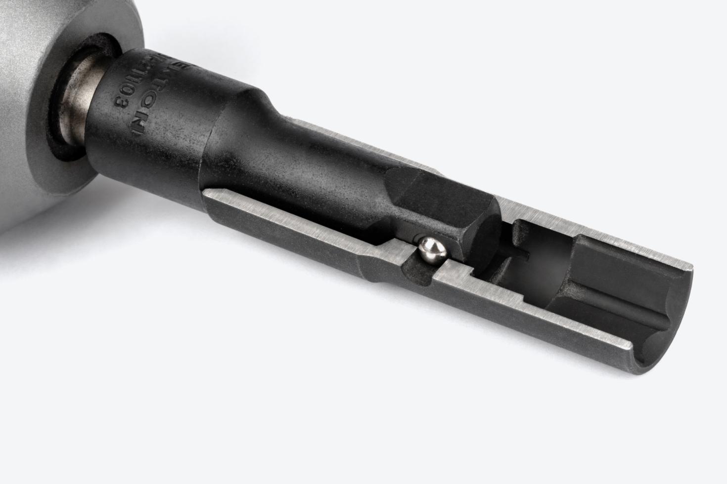 An impact flip socket that's been cut in half on an extension and impact wrench, showing the deep well and thin walls