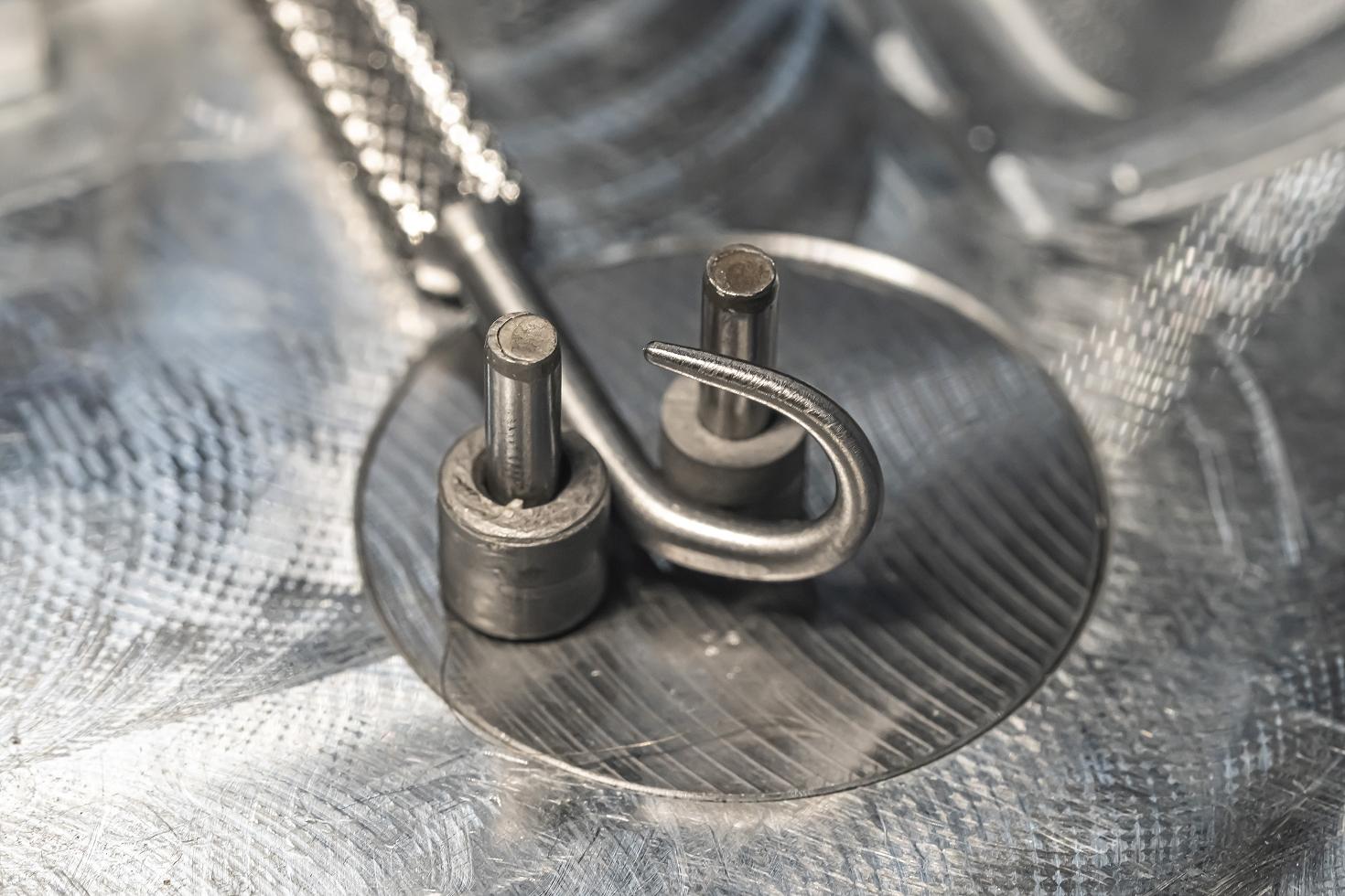 The hook end of Tekton #PNH70000 being bent on a machine.