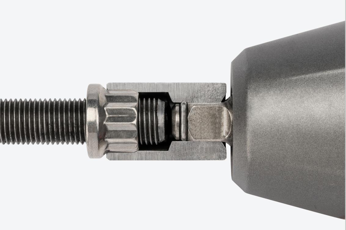 A shallow 12-point impact socket cut in half to show the full-length socket well