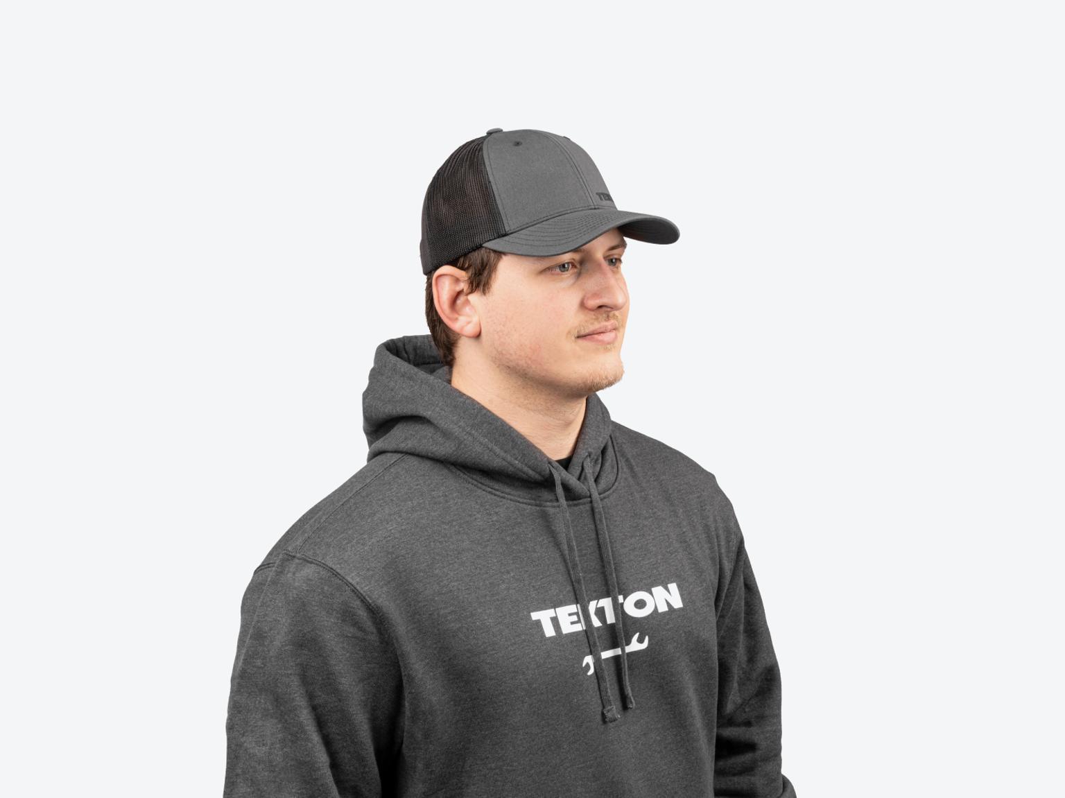 A man wearing a dark heather gray heavyweight Tekton hoodie.