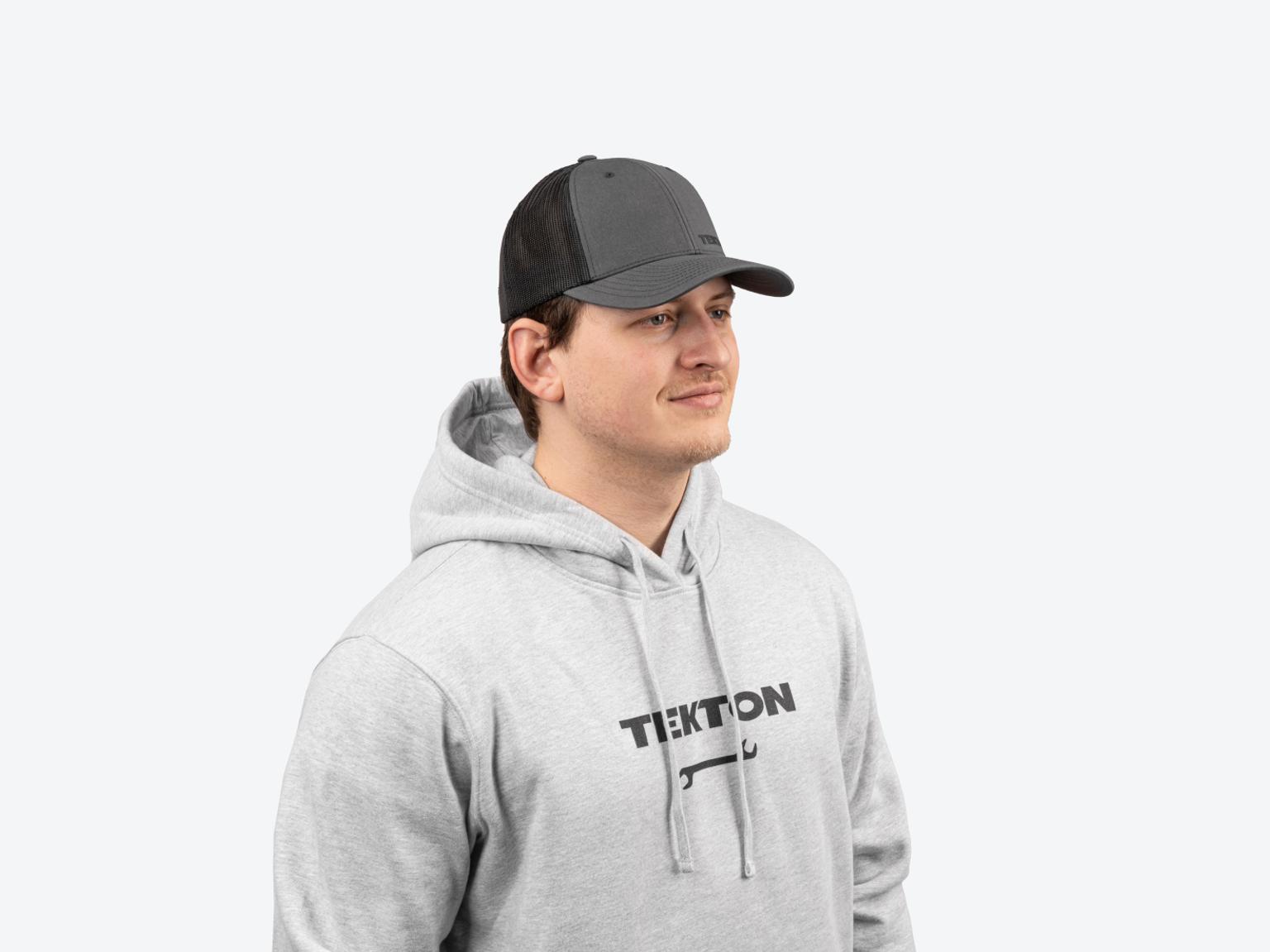 A man wearing a light heather gray heavyweight Tekton hoodie.