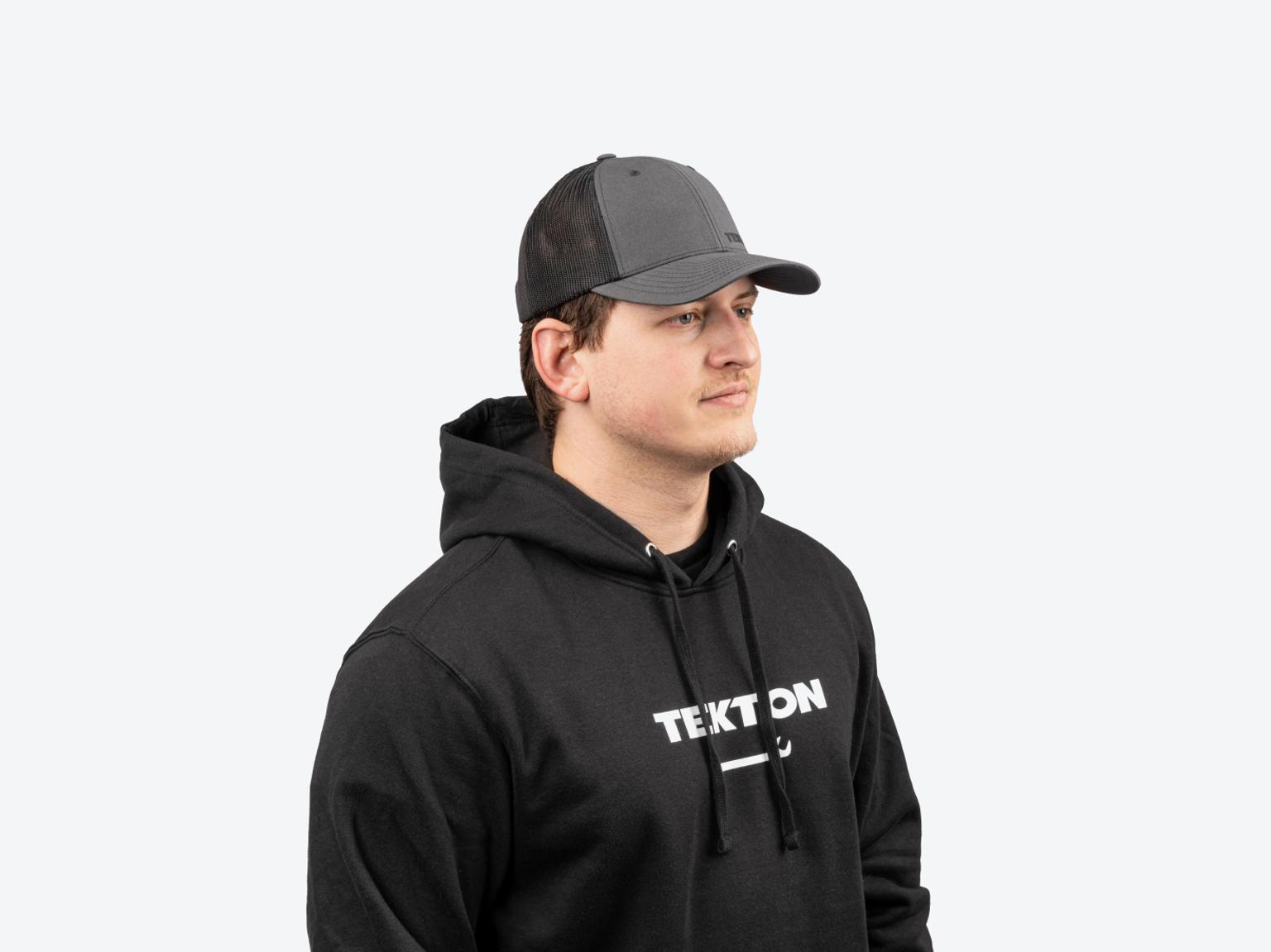 A man wearing a black midweight Tekton hoodie.