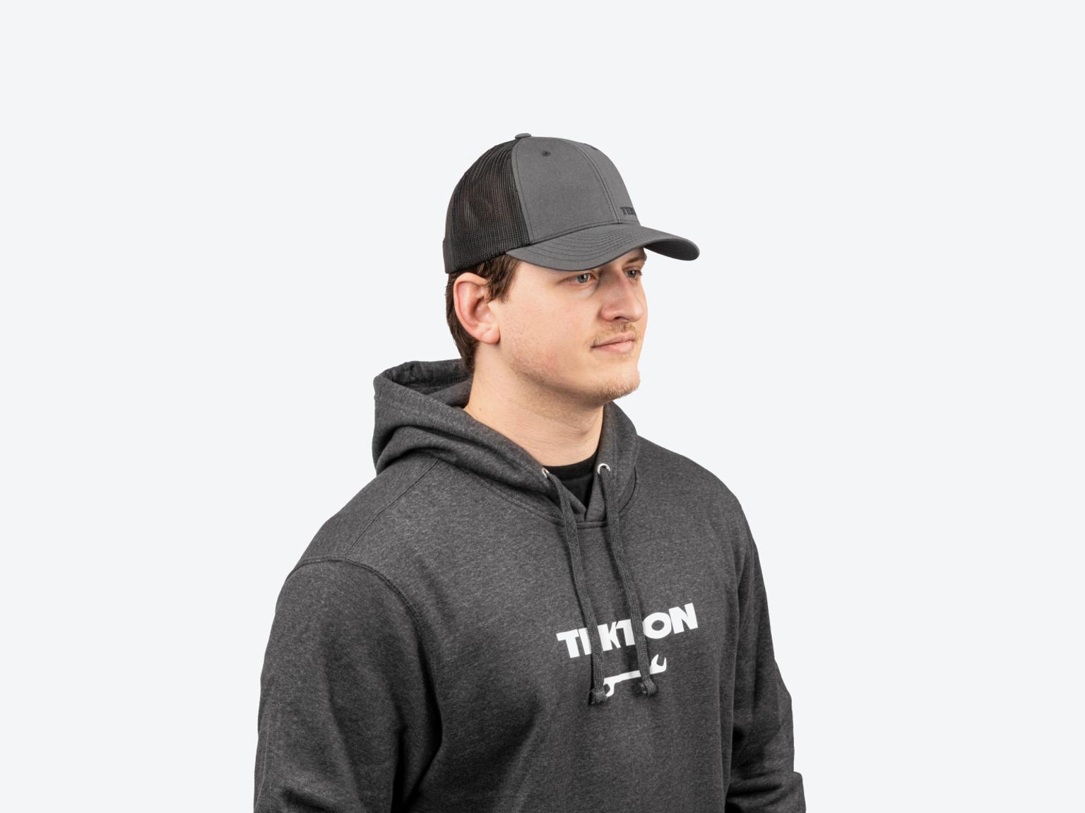 A man wearing a dark heather gray midweight Tekton hoodie.