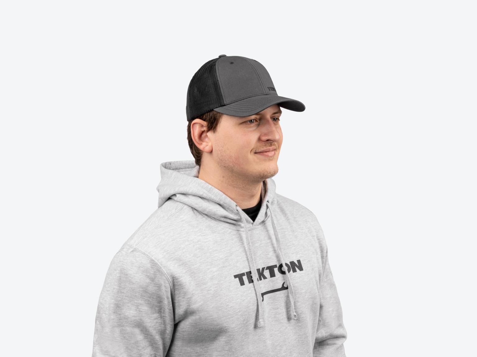 A man wearing a light heather gray midweight Tekton hoodie.