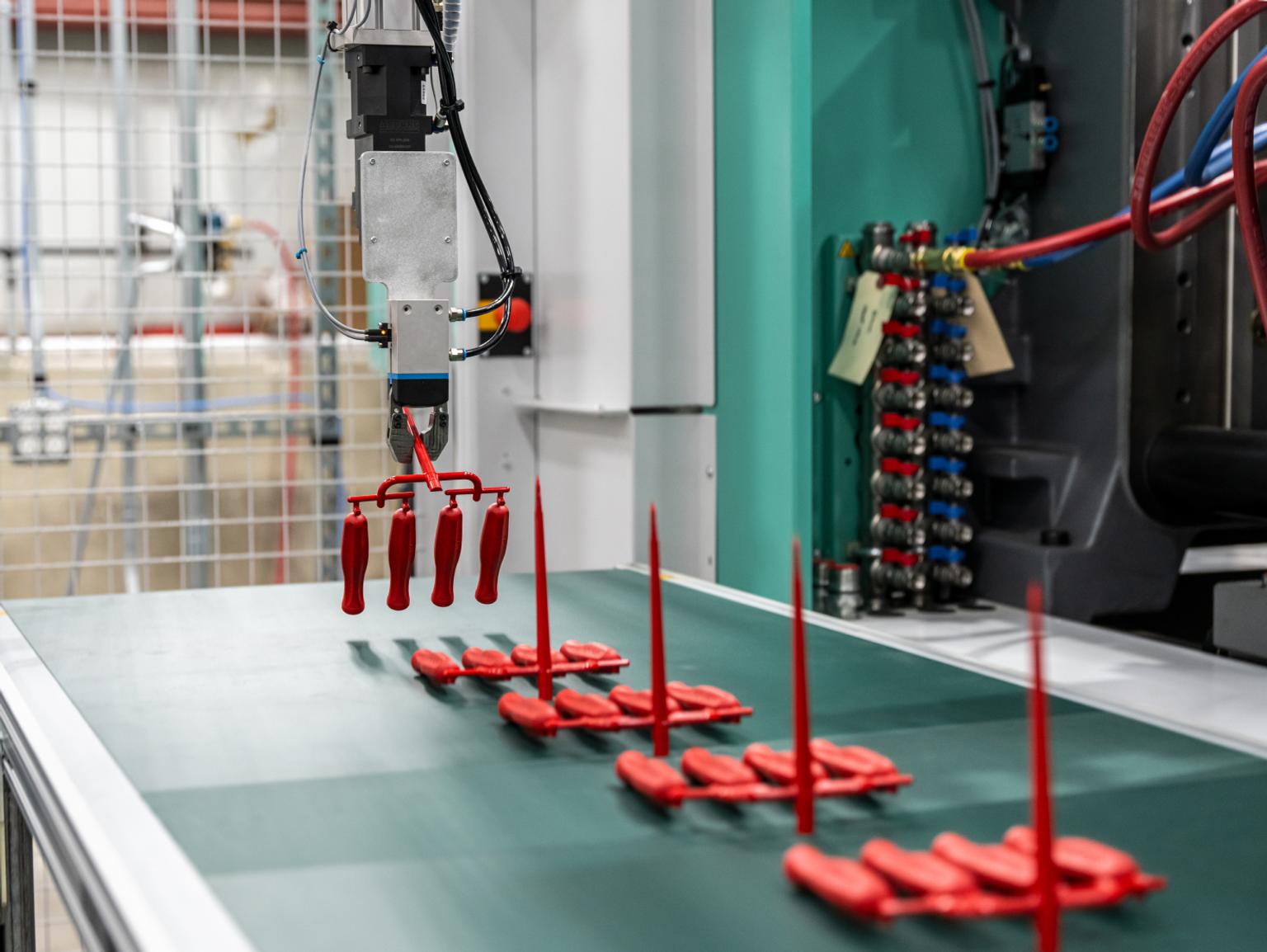 Red Tekton pick and hook handles on a production line.