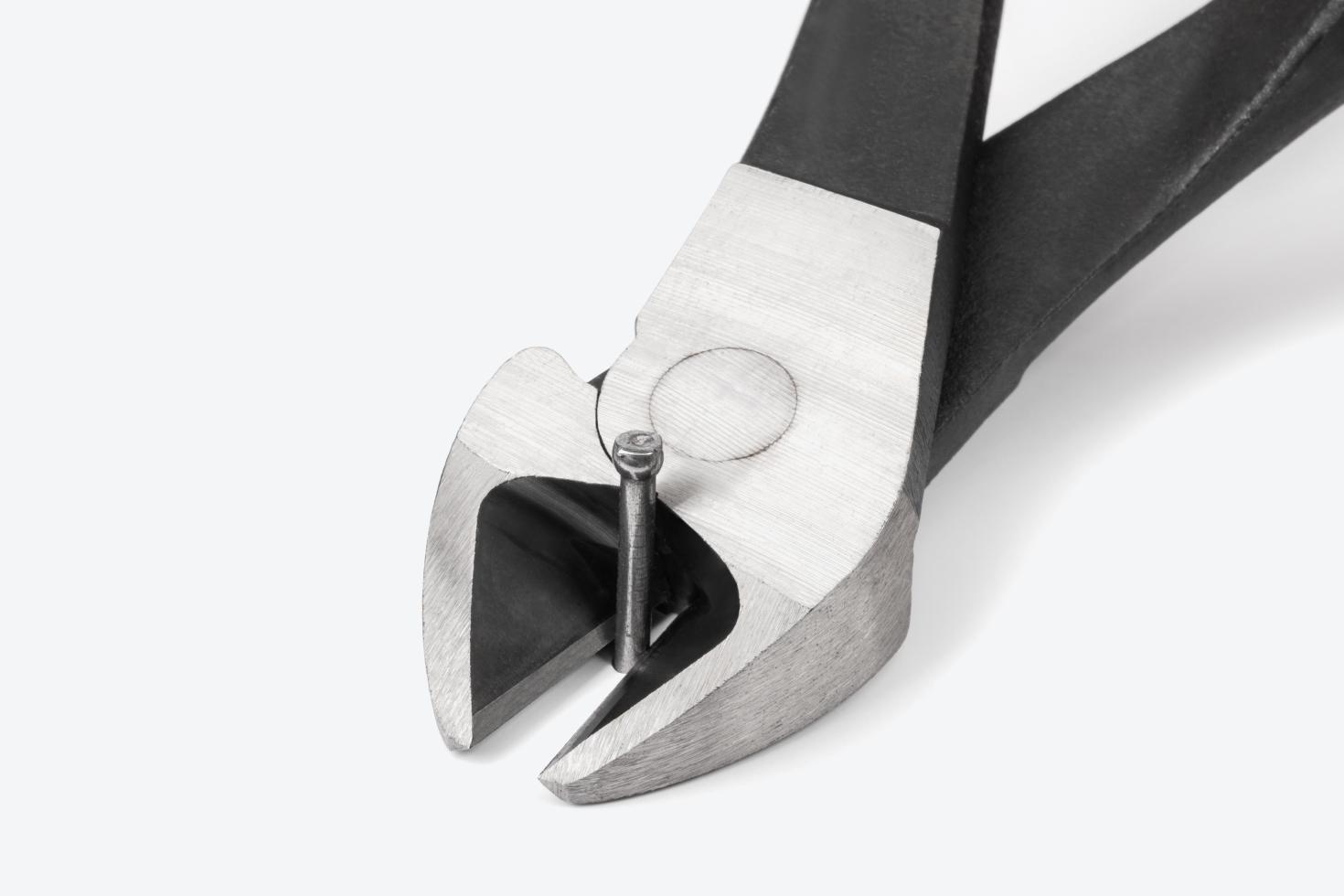 Pliers cutting a nail