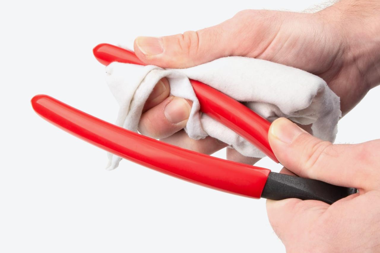 The vinyl grips of the pliers being cleaned