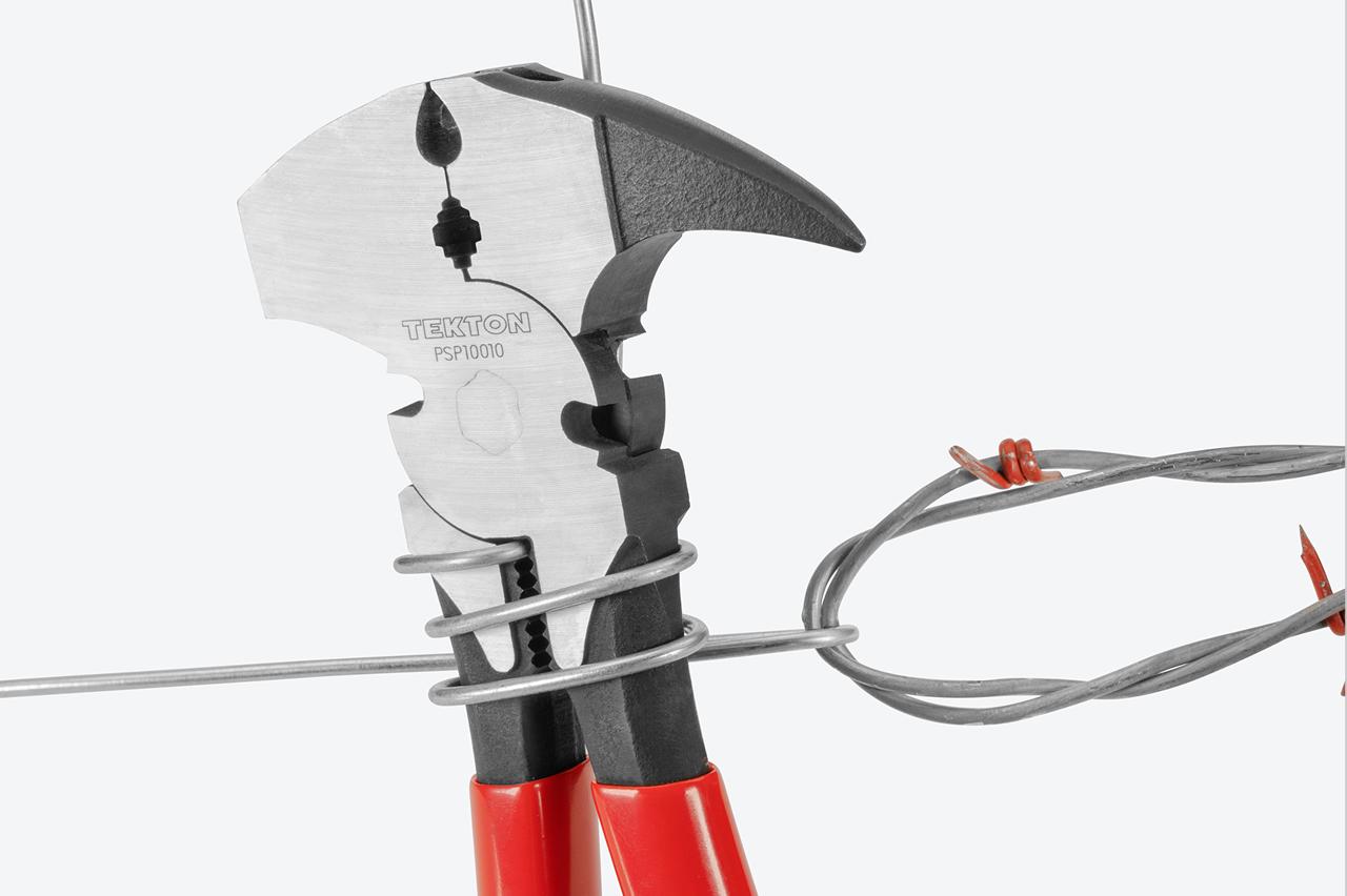 The pliers gripping and stretching wire