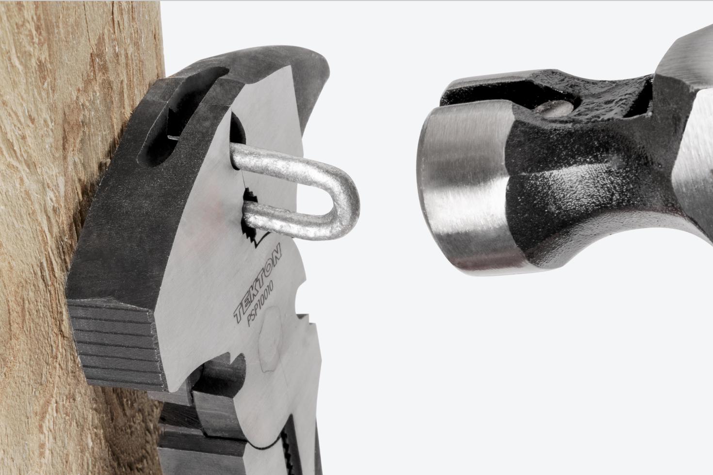 The pliers holding a staple