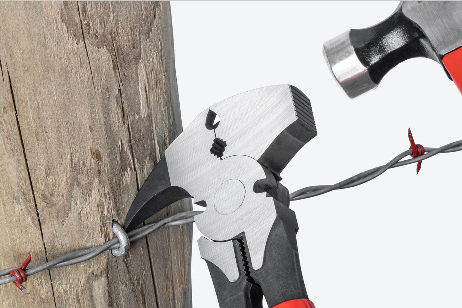A hammer being used to drive the claw under a staple