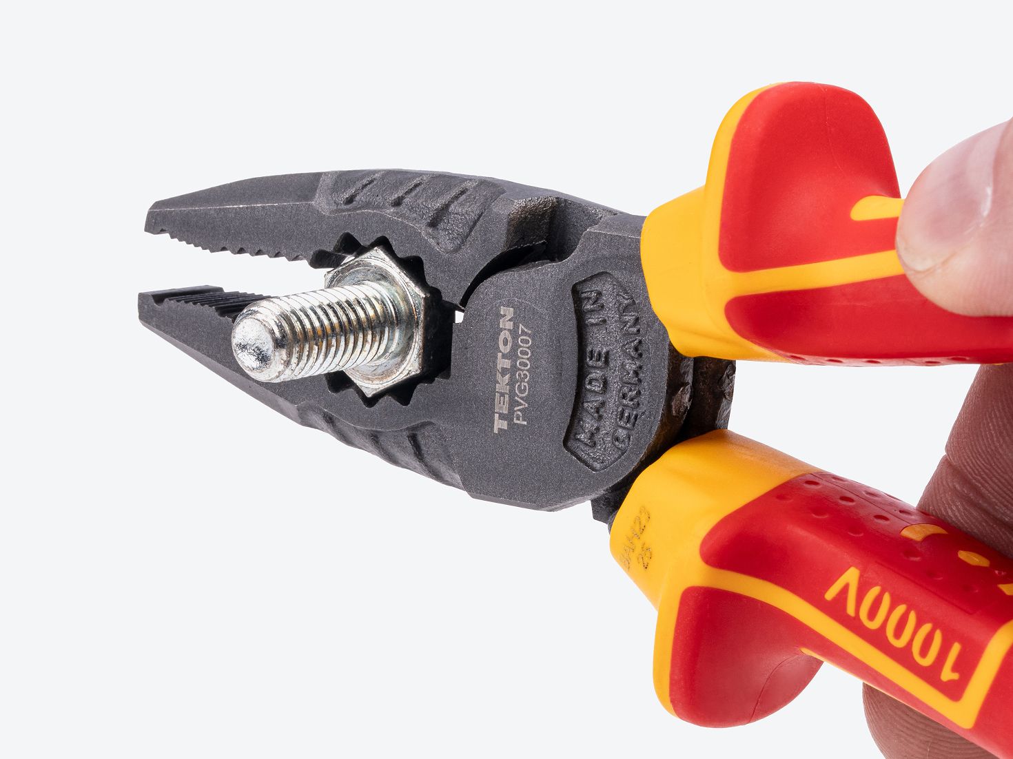 Tekton insulated combination pliers #PVG30007 holding a hex bolt.