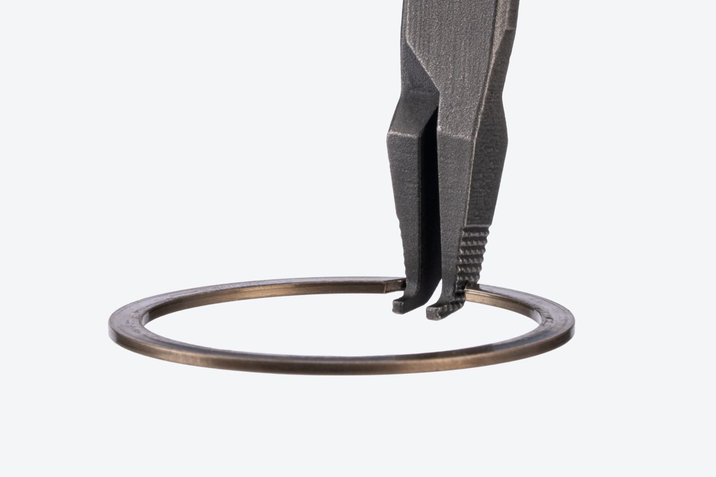 A ring on a pair of Tekton curved tip lock ring pliers #PRR53206