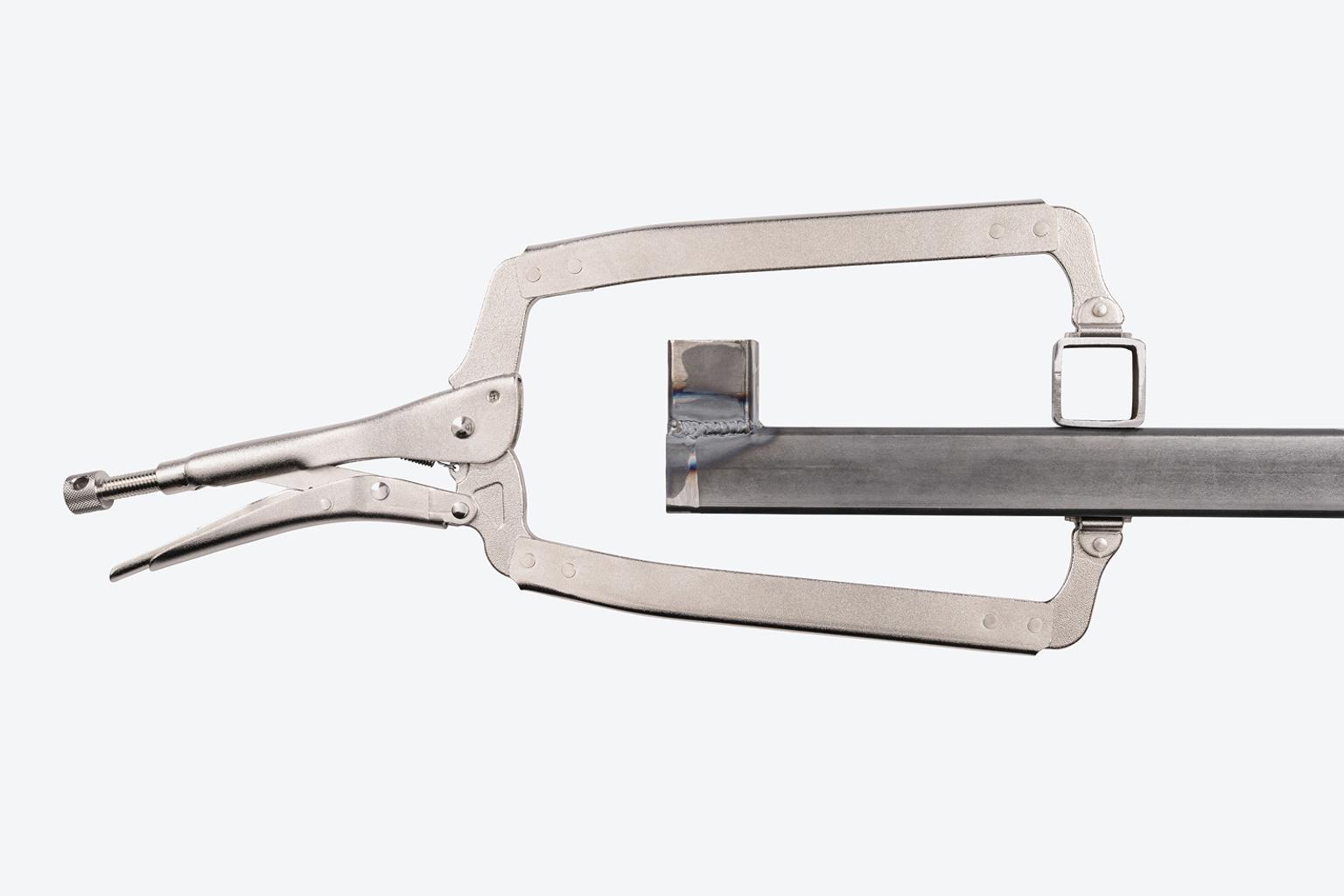The long jaws of a Tekton swivel pad locking C-clamp #CLC11018 reaching around an obstruction.
