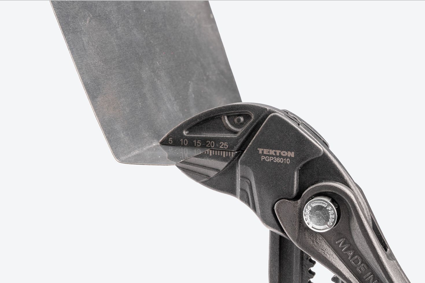 A pliers wrench clamping onto sheet metal.