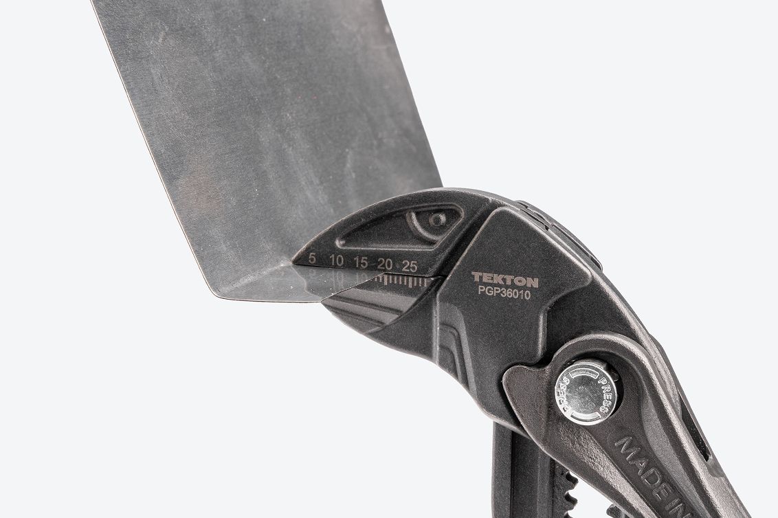 A pliers wrench clamping onto sheet metal.