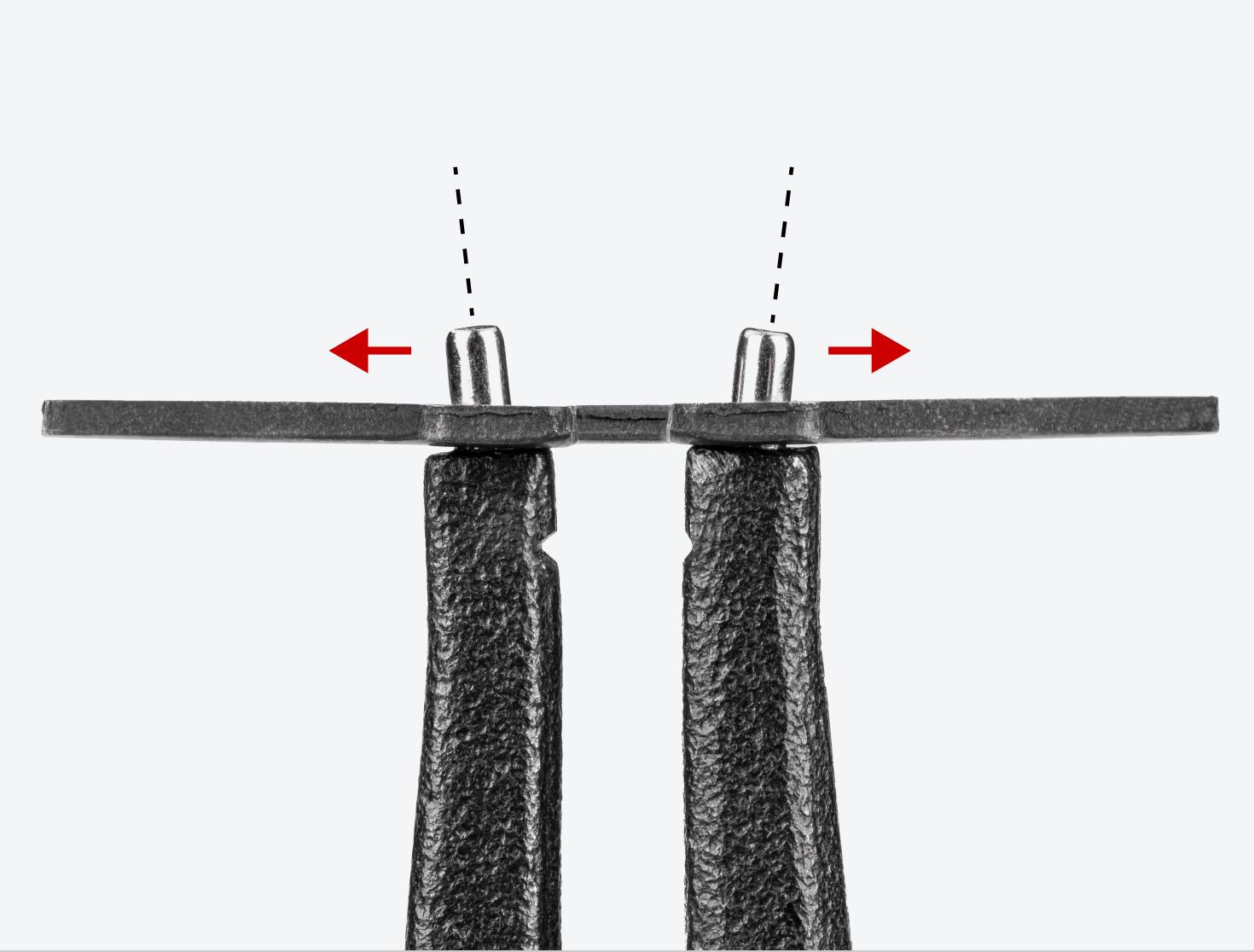 Graphic showing how the tips of the pliers are angled outward to hold the ring in place.
