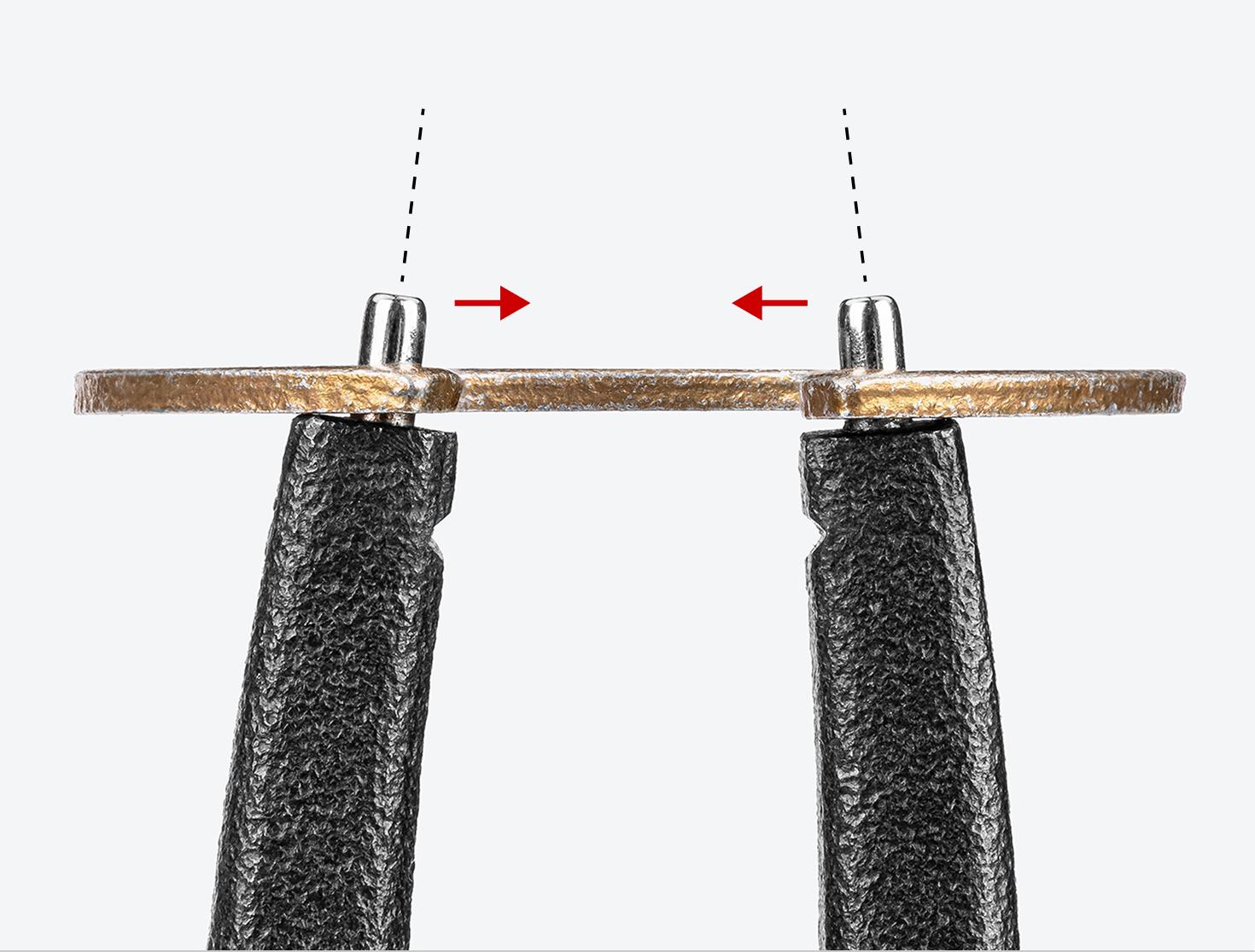 Graphic showing how the tips of the pliers are angled inward to hold the ring in place.