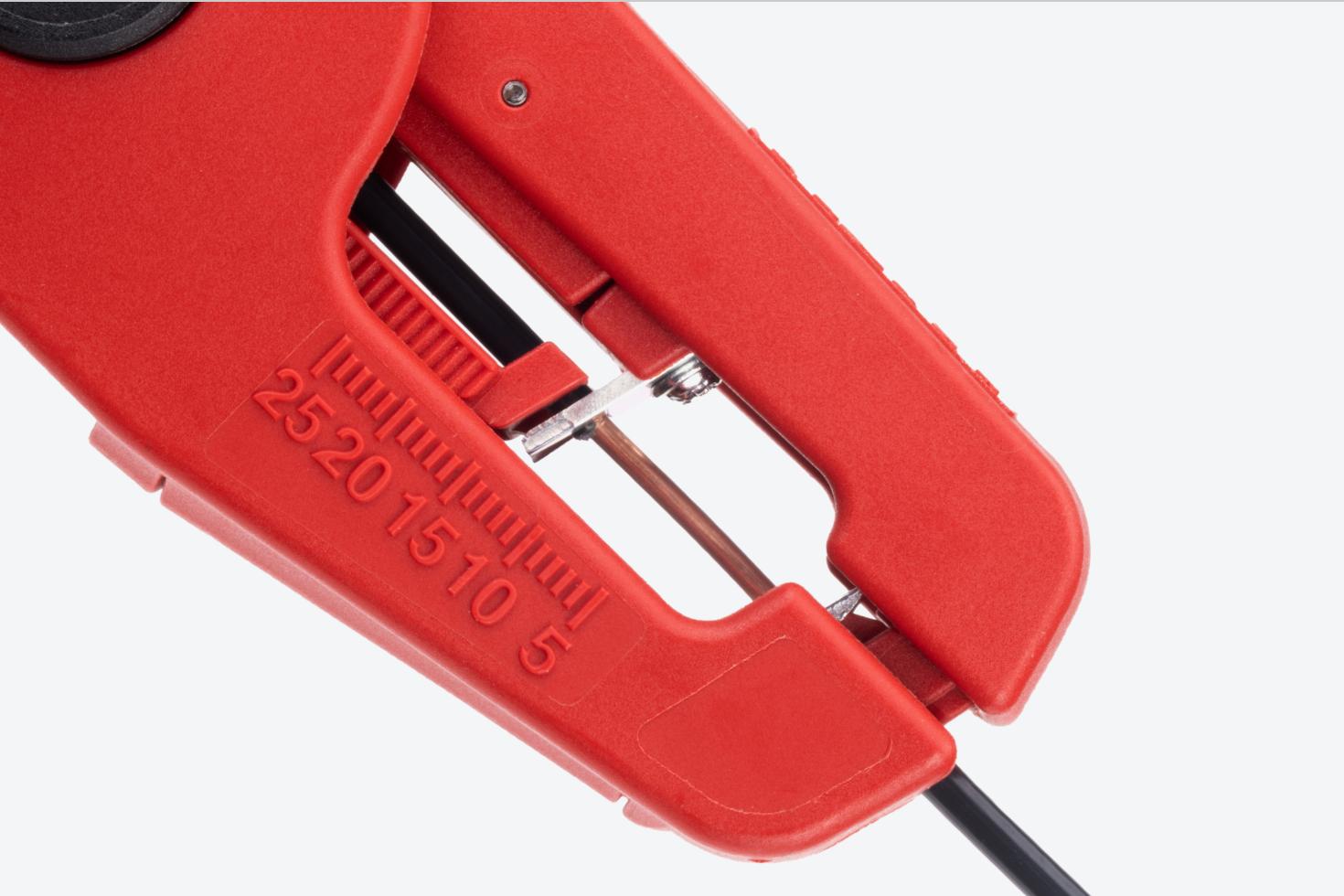 Close-up view of the wire strippers stripping the insulation from a wire.