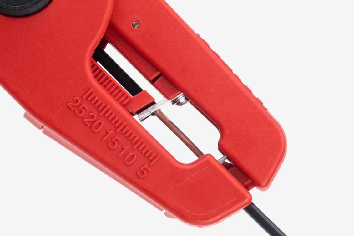 Close-up view of the wire strippers stripping the insulation from a wire.