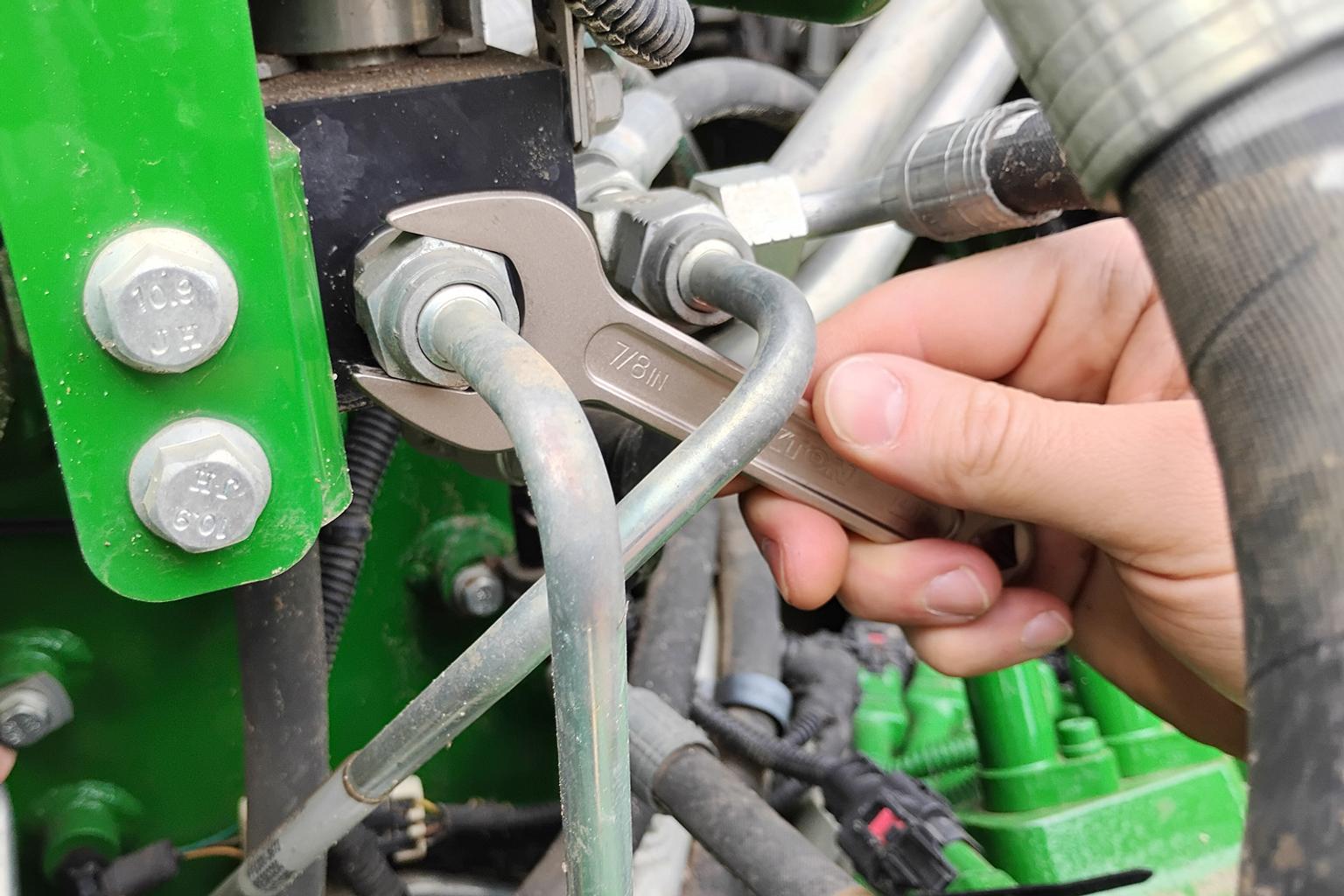 A service wrench on a hydraulic line.