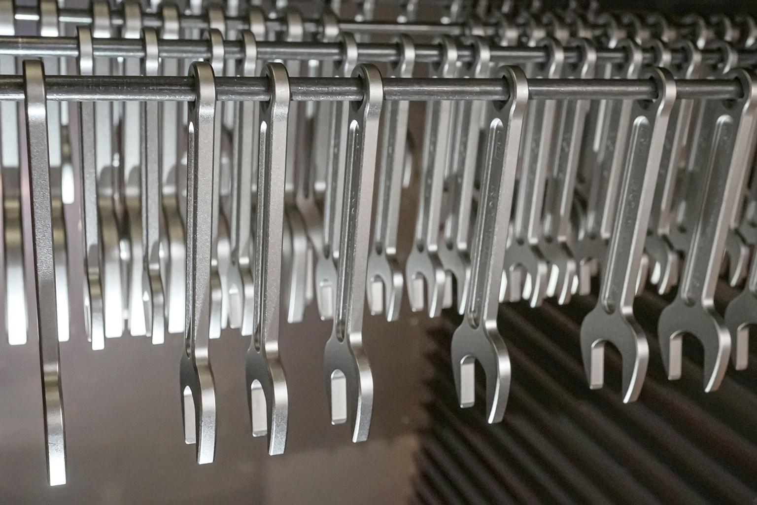 Service wrenches hanging on a rod.
