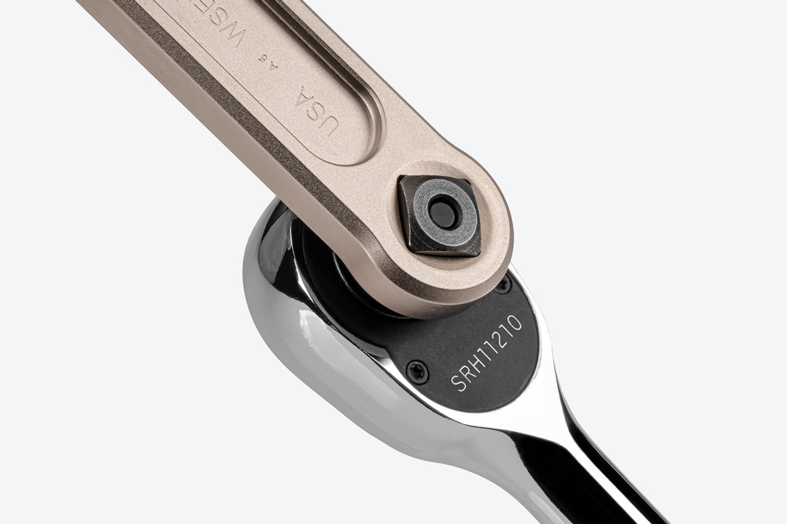 A ratchet connected to the drive square in the handle of a Tekton service wrench.
