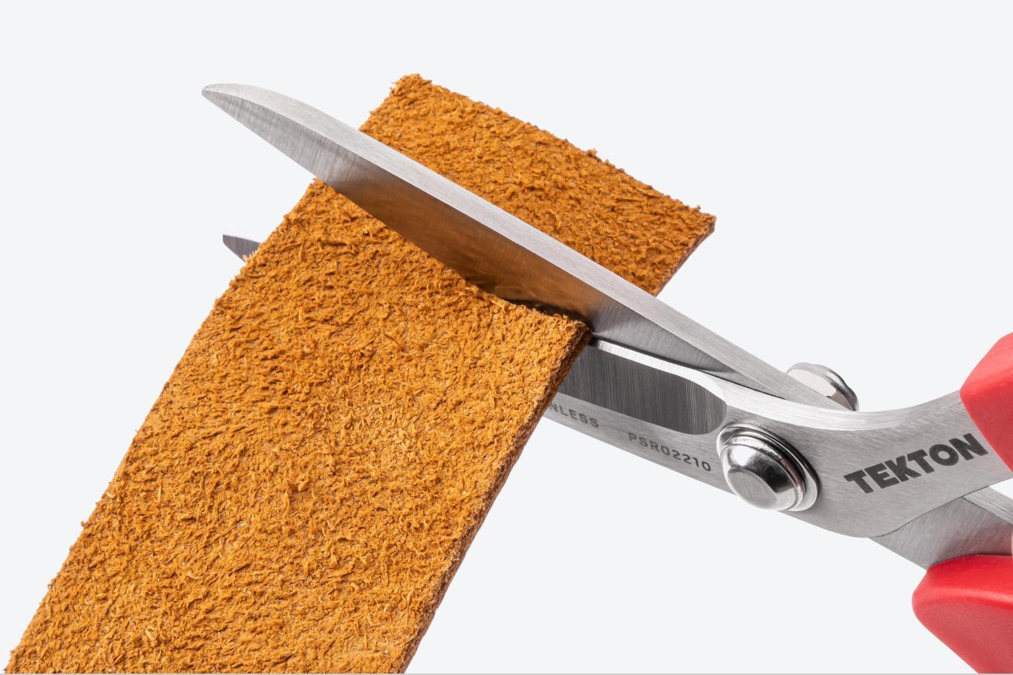 Scissors cutting leather
