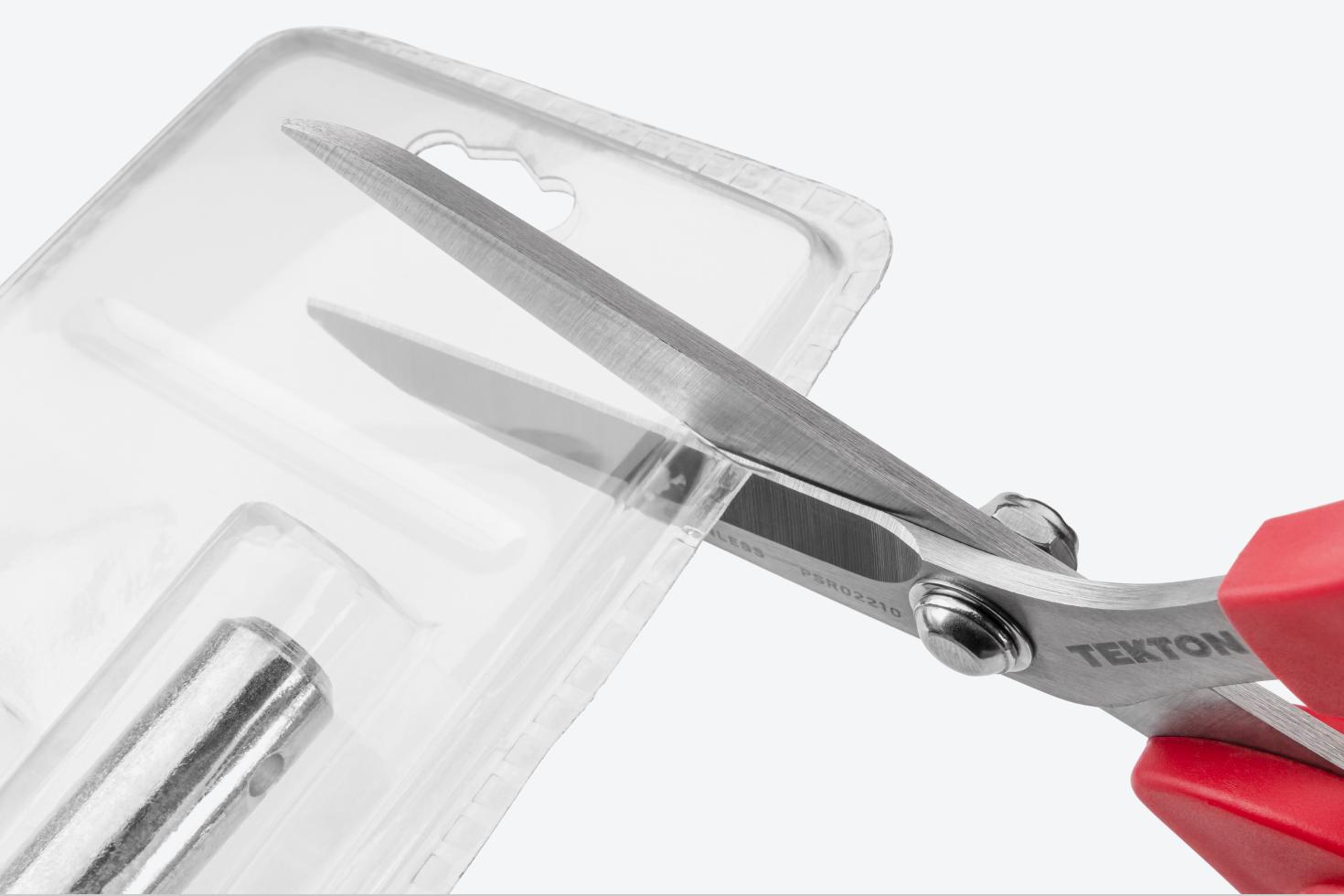 Scissors cutting plastic packaging