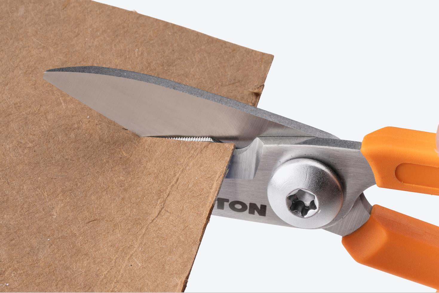 Scissors cutting cardboard