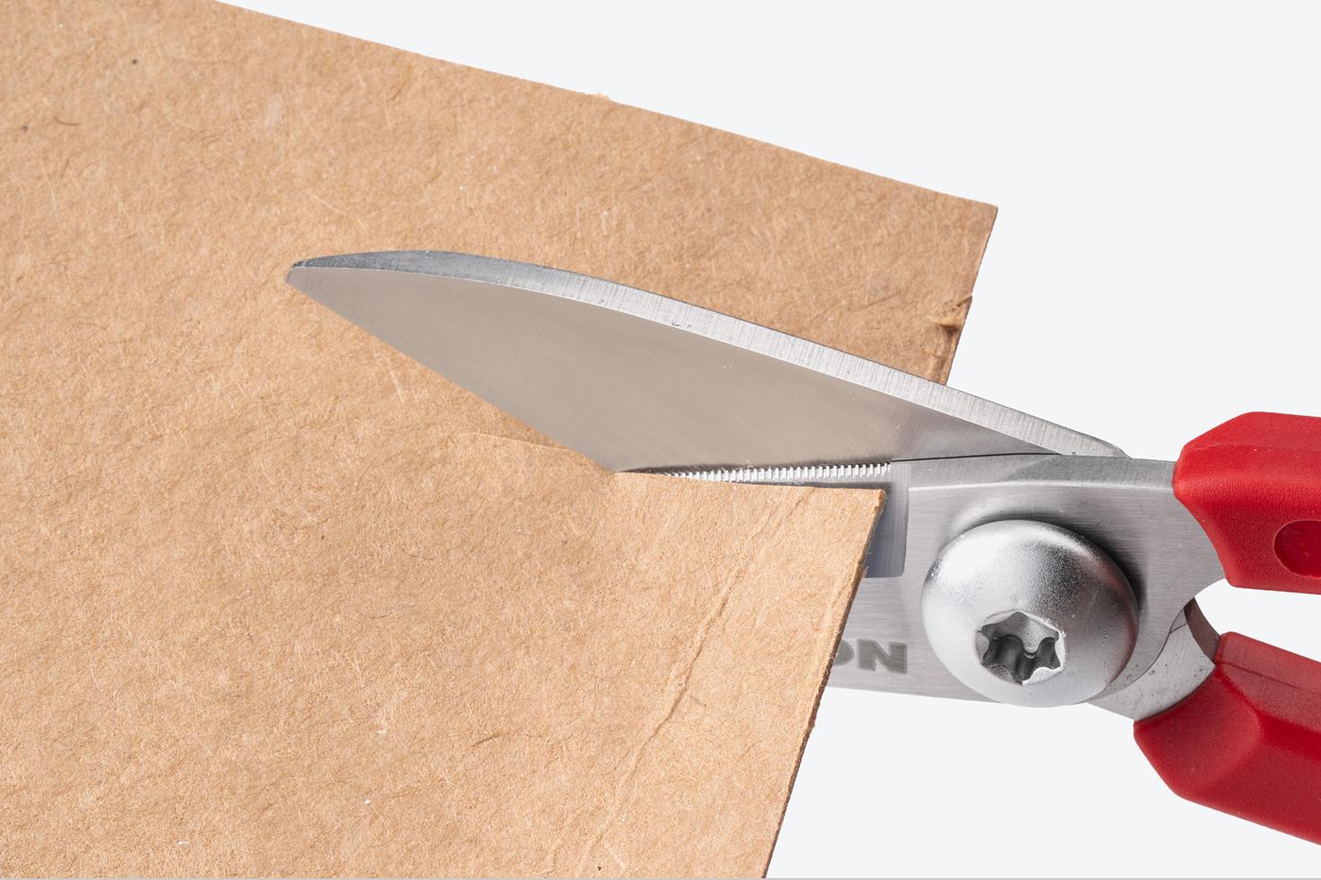 Scissors cutting cardboard