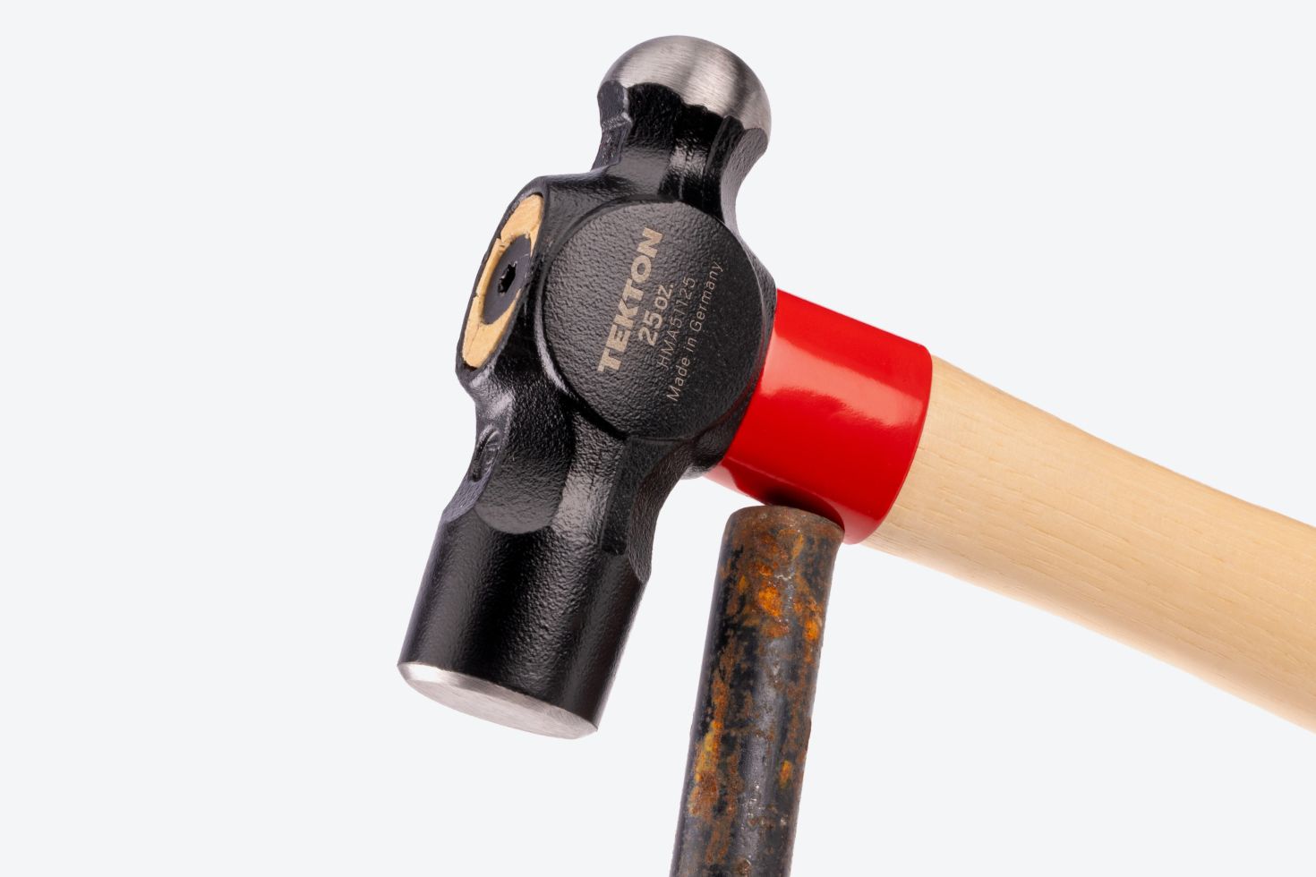 The collar of a Tekton ball peen hammer hitting a rod