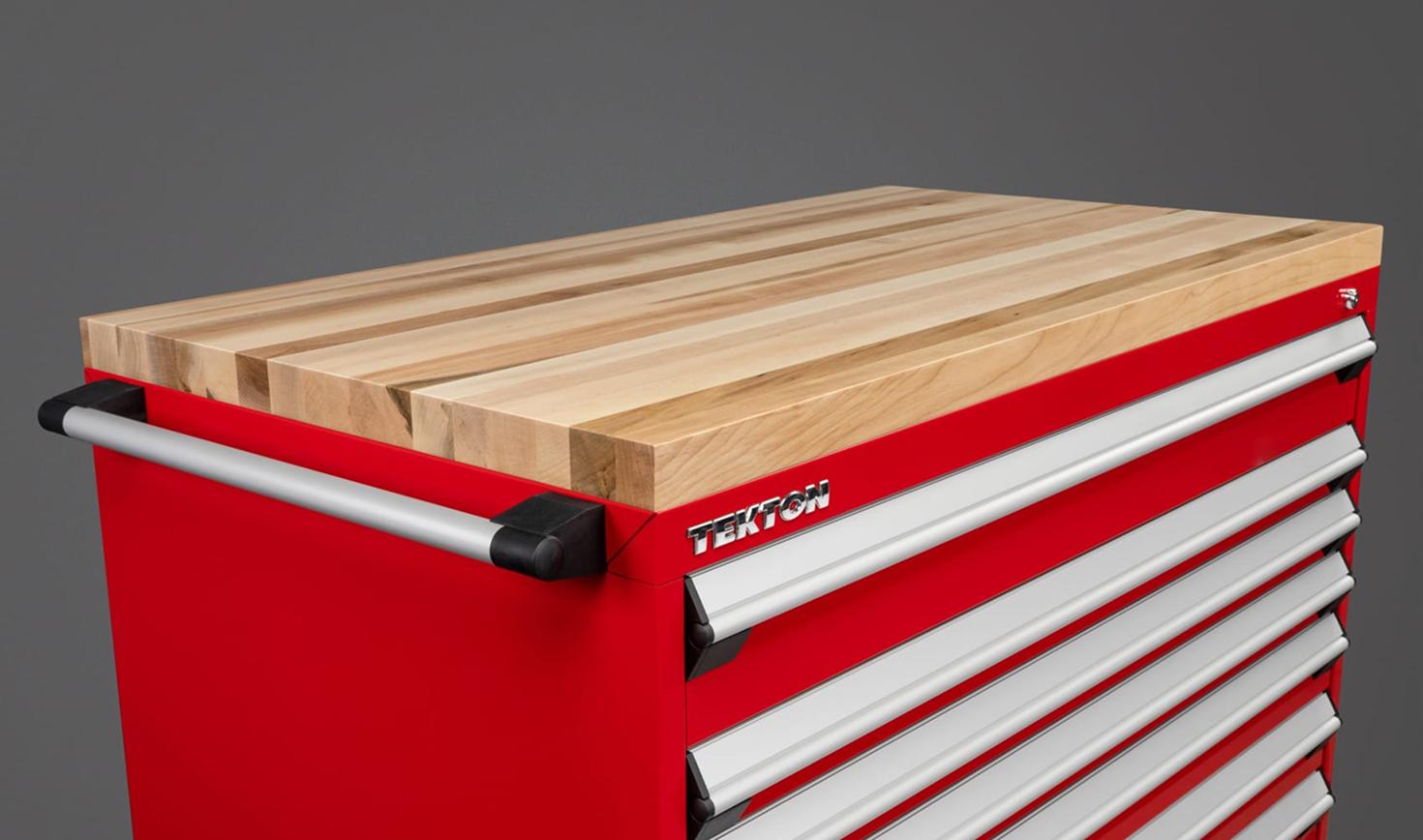A red Tekton tool cabinet with a hardwood block cabinet top