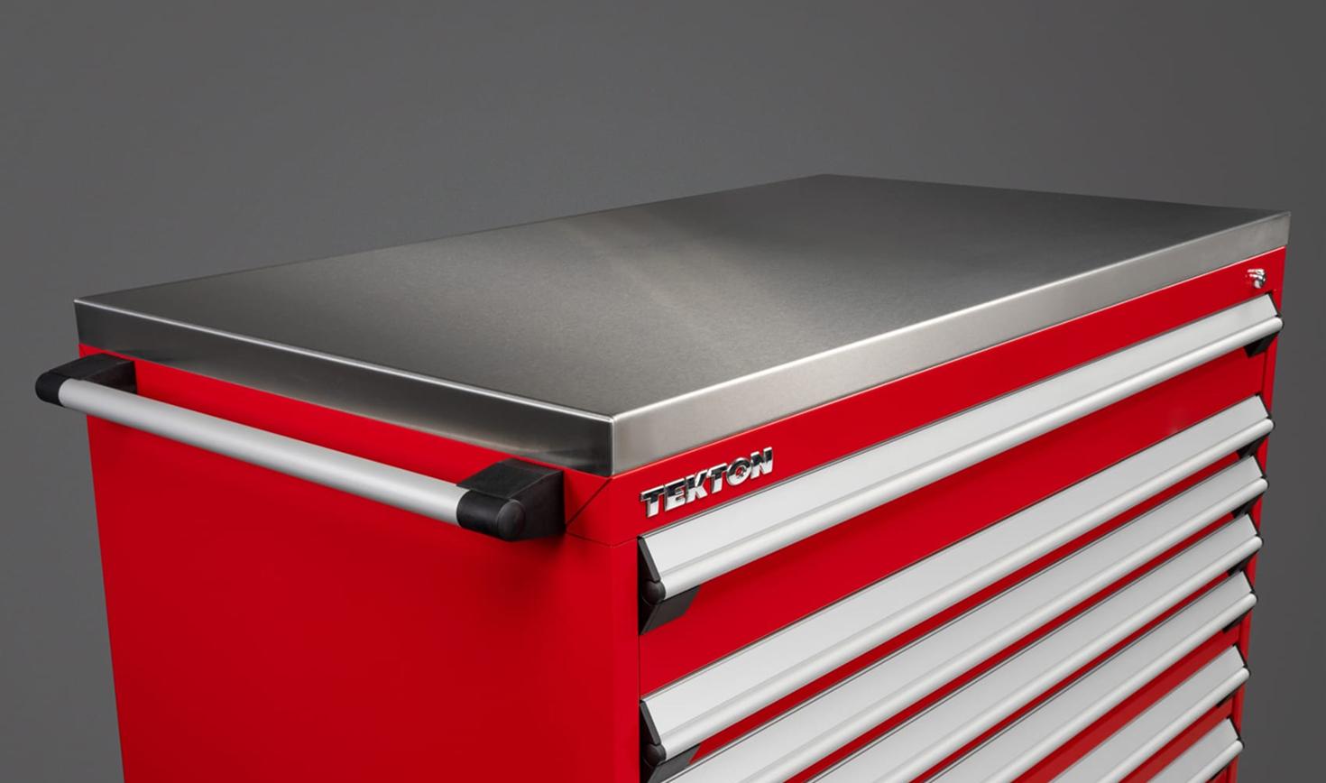 A red Tekton tool cabinet with a stainless steel cabinet top