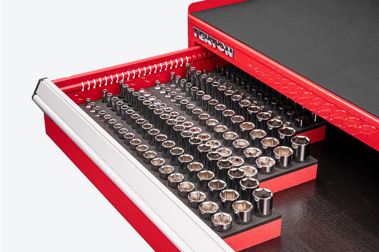 Sockets in foam organizers in the top drawer of a red Tekton tool cabinet
