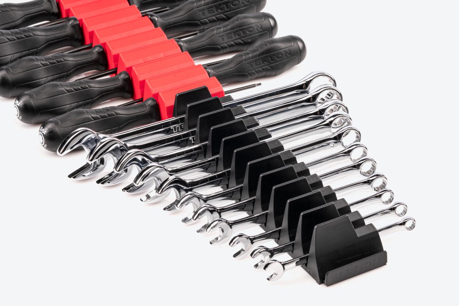A set of Tekton combination wrenches in black modular wrench organizers and a set of Tekton drivers in red modular driver organizers. All of the organizers are connected.