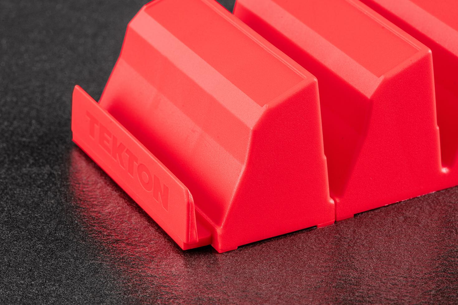 A red Tekton modular driver organizer on a black tool cabinet drawer liner.