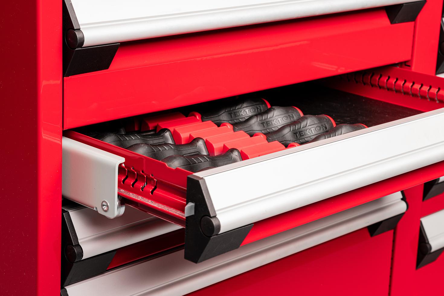 Tekton high torque screwdrivers in red modular driver organizers in a shallow drawer of a red tool cabinet.
