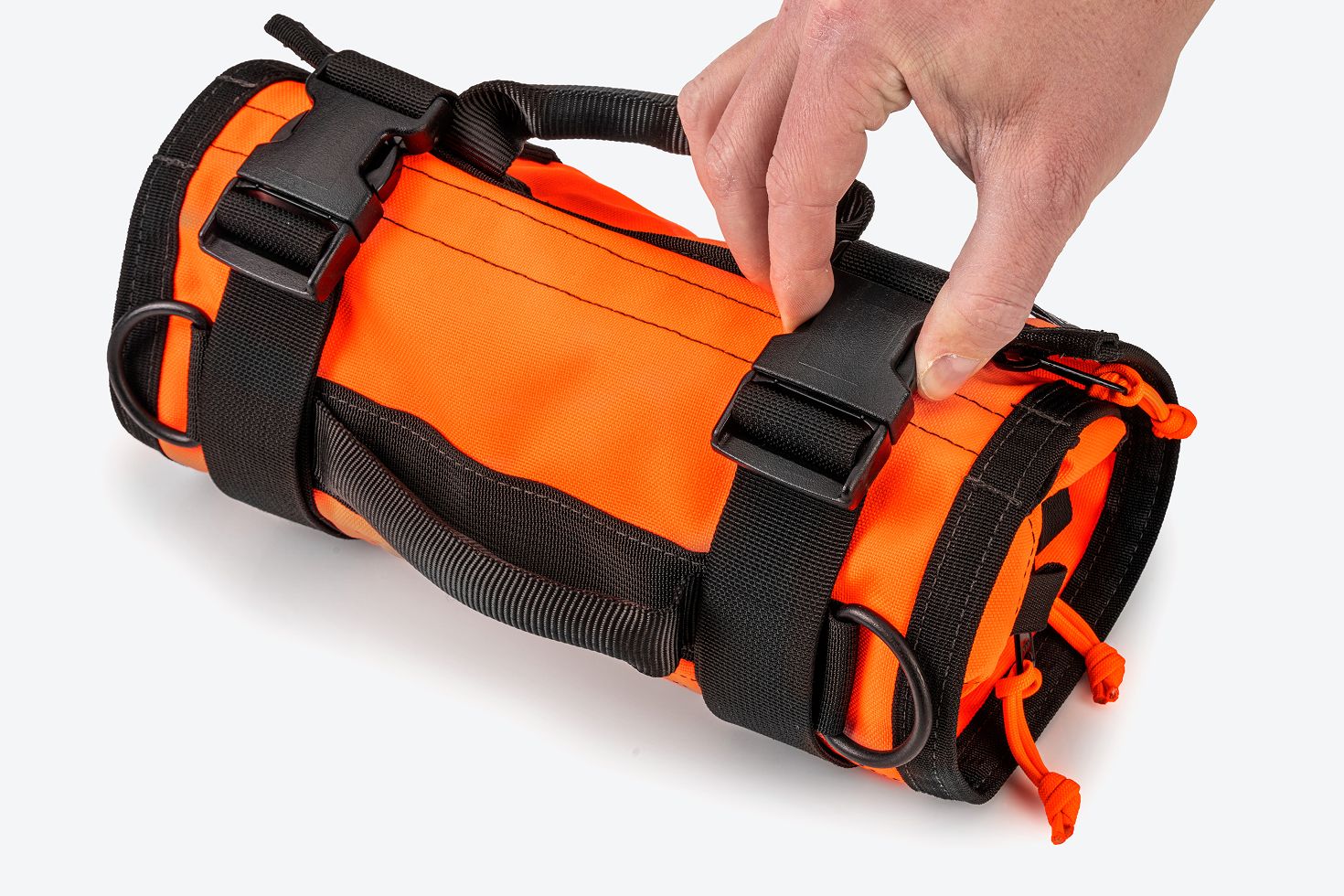 A hand unbuckling an orange MTR