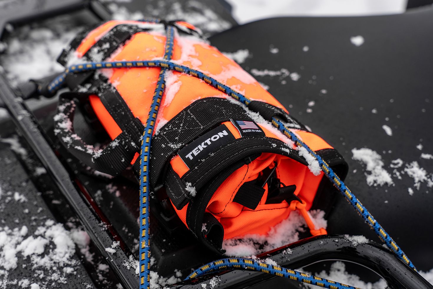 An orange MTR2 Mini tied down with bungee straps