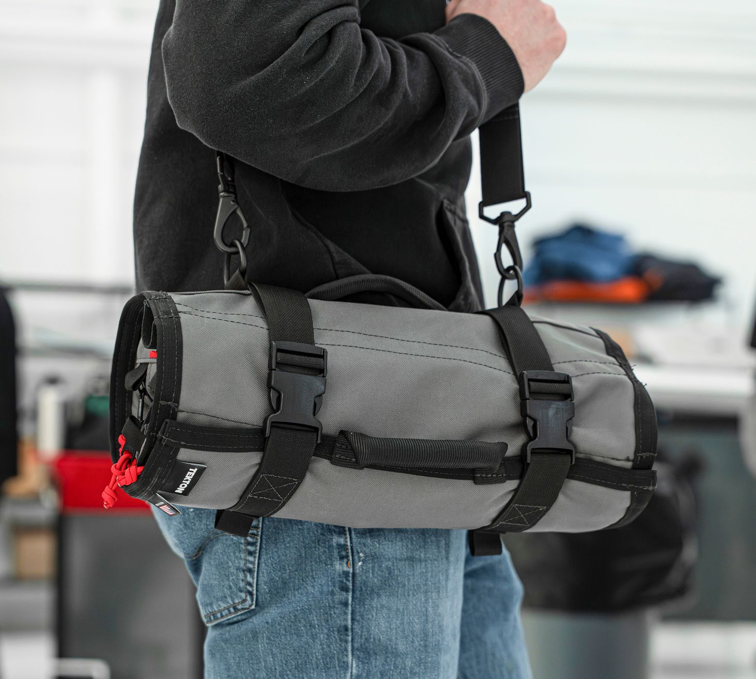 A person carrying an MTR using a shoulder strap