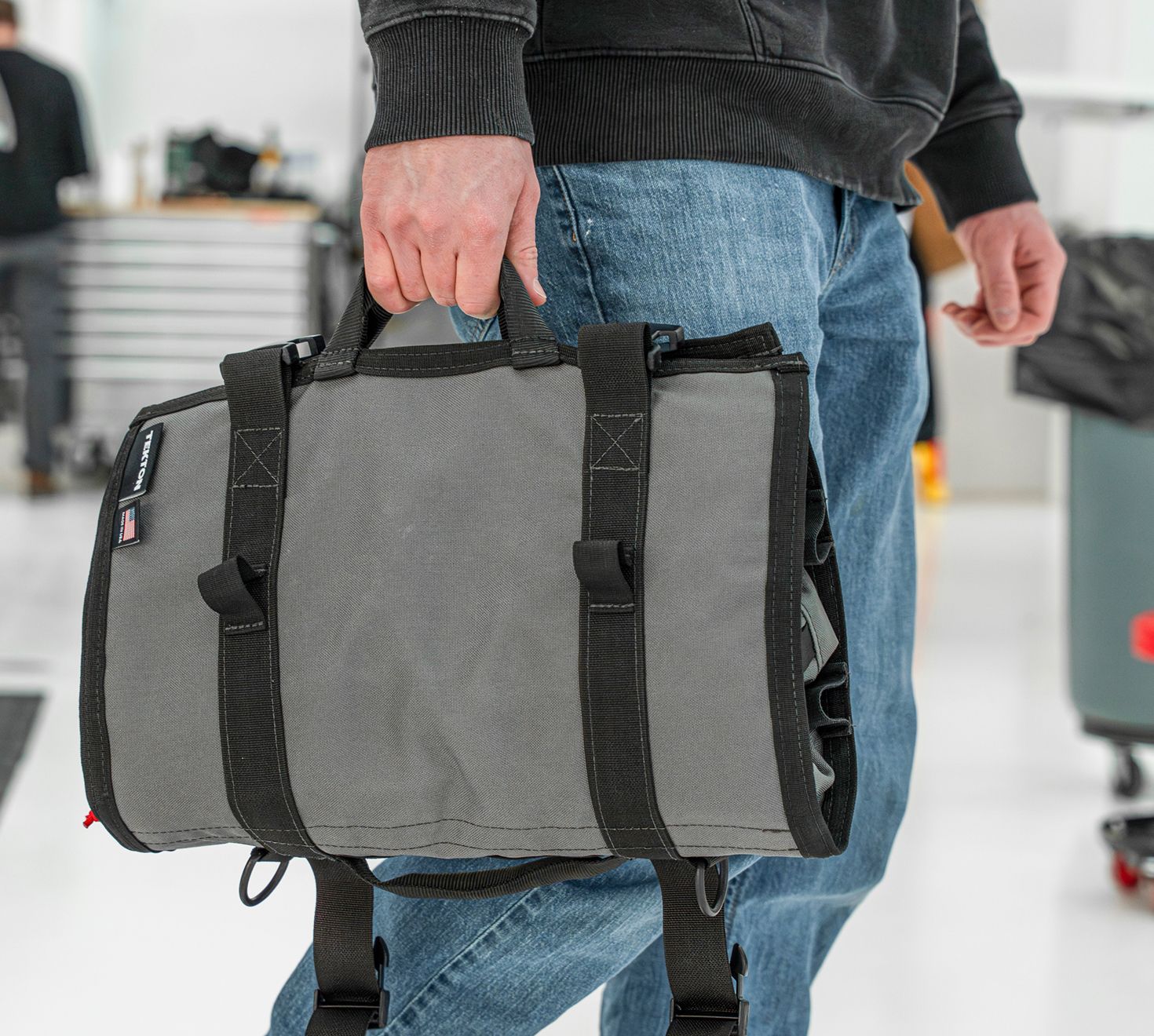 A person carrying an MTR using the side handles.
