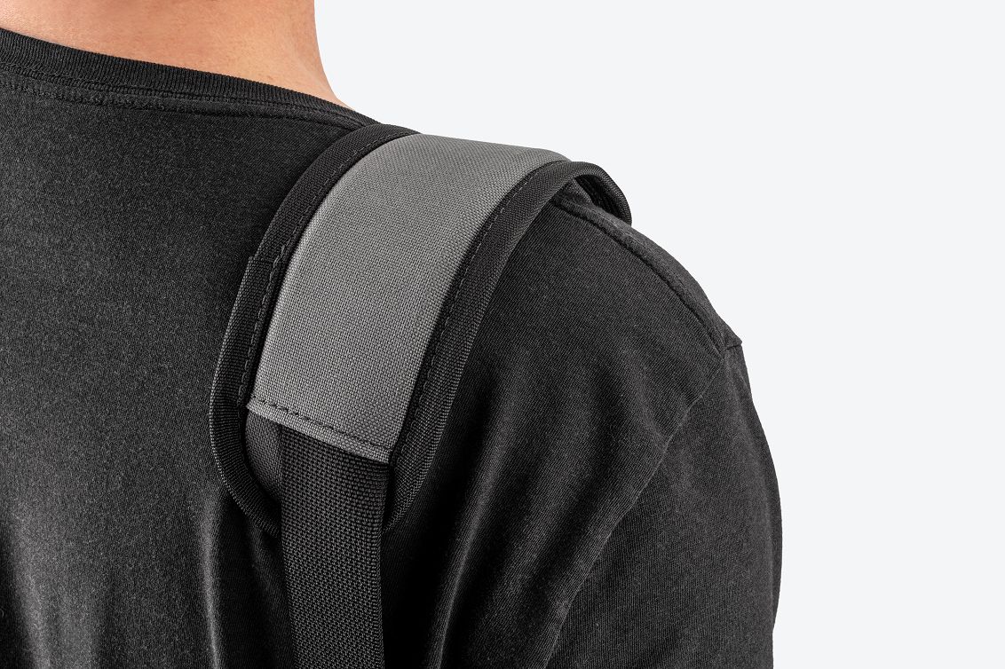A padded shoulder strap on a person's shoulder