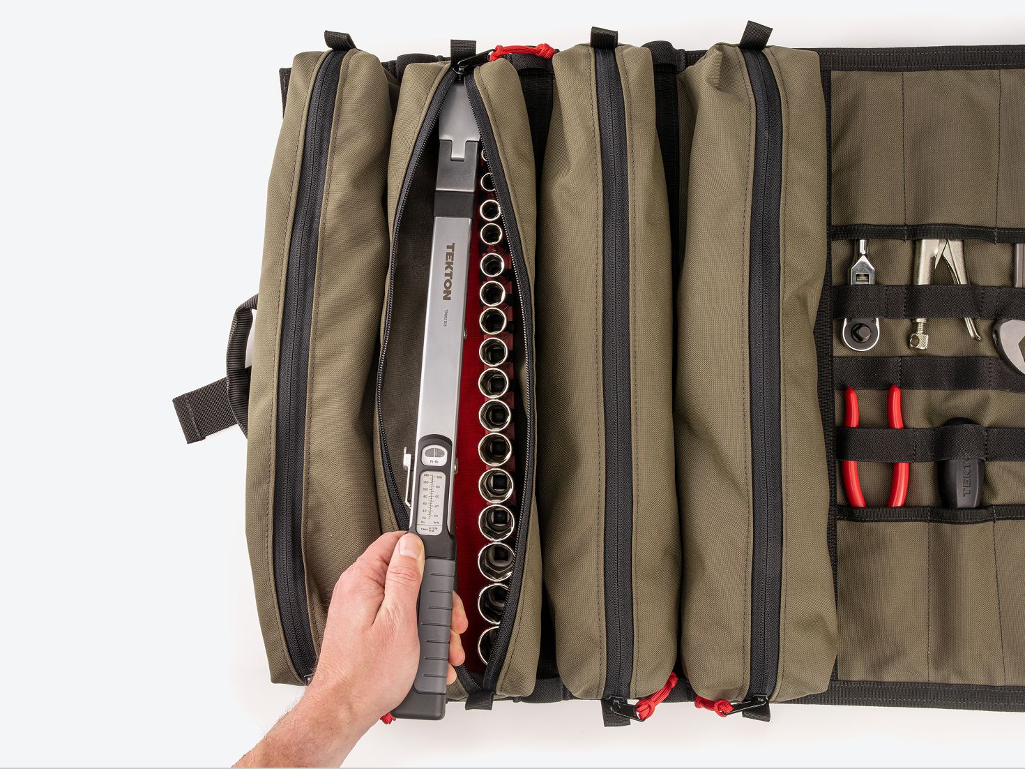 A hand pulling a split beam torque wrench out of a green MTR4 XL