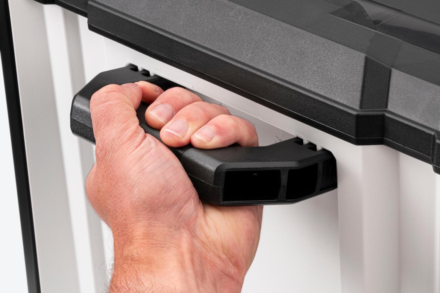 A hand holding onto the handle