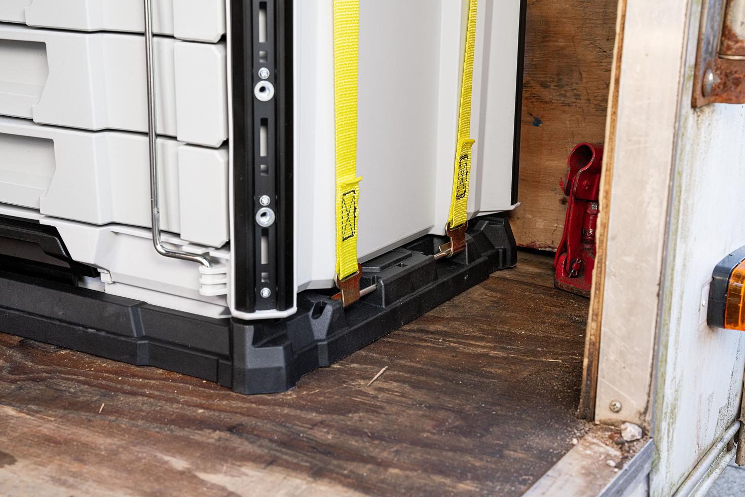 5-drawer tool boxes strapped onto a mounting plate on the floor of an enclosed trailer