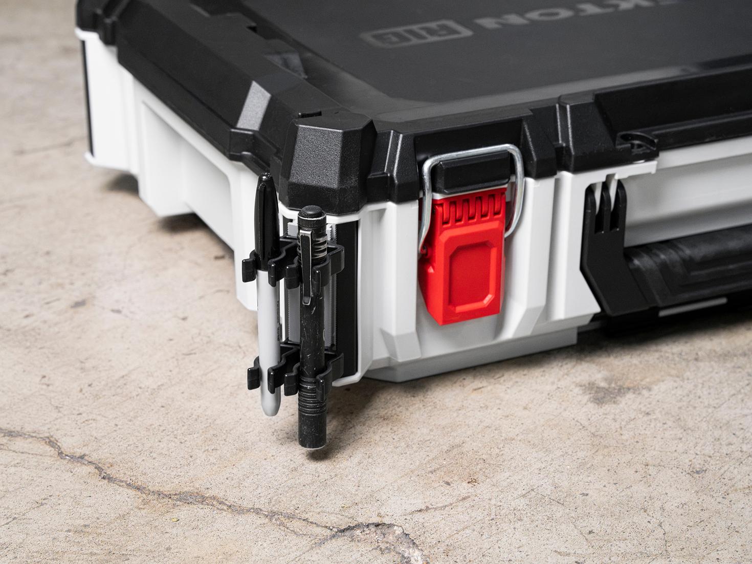 A tool box with holders for a marker and pen light attached to the side rails
