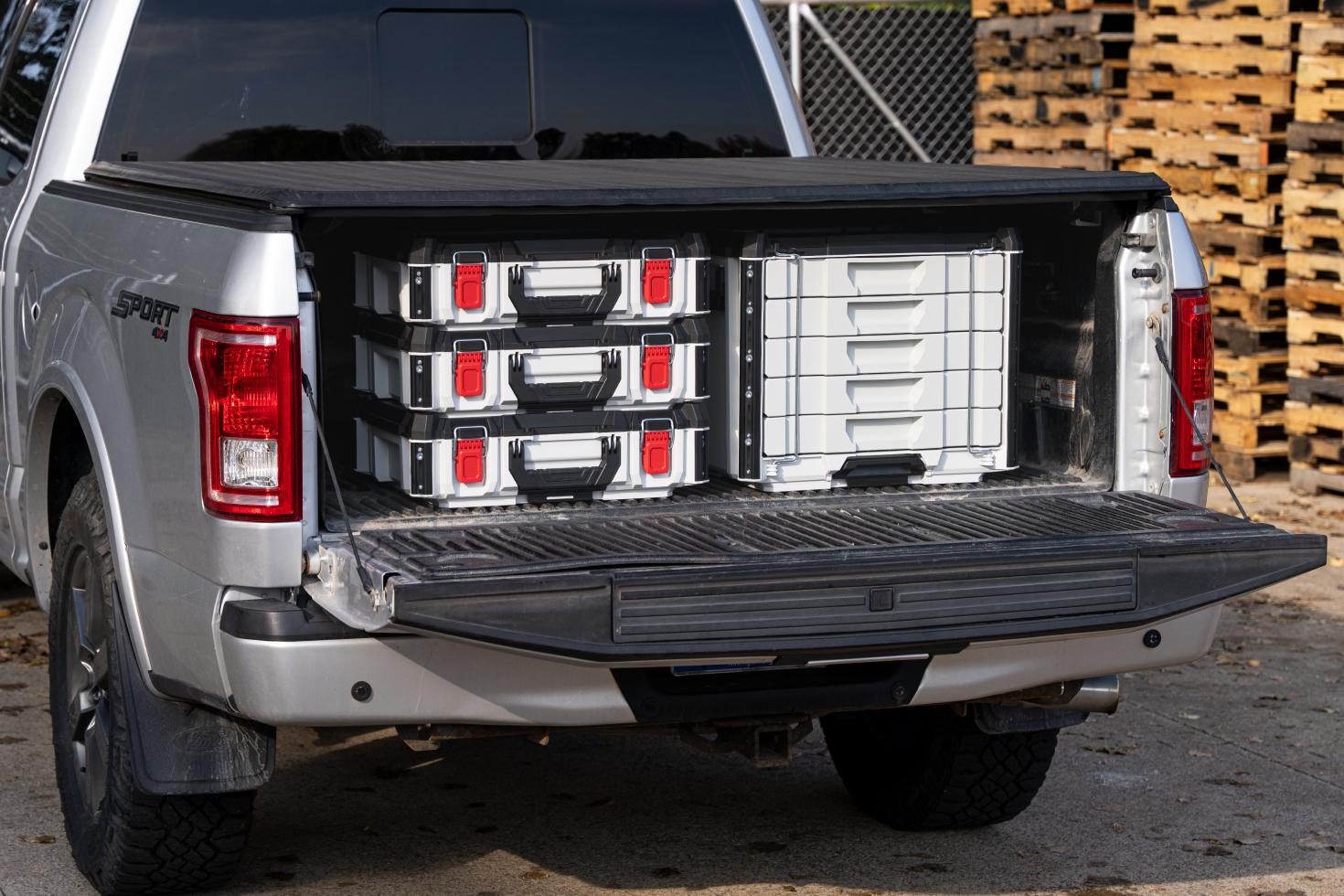 Three tool boxes and a 5-drawer tool box in the back of a pickup truck