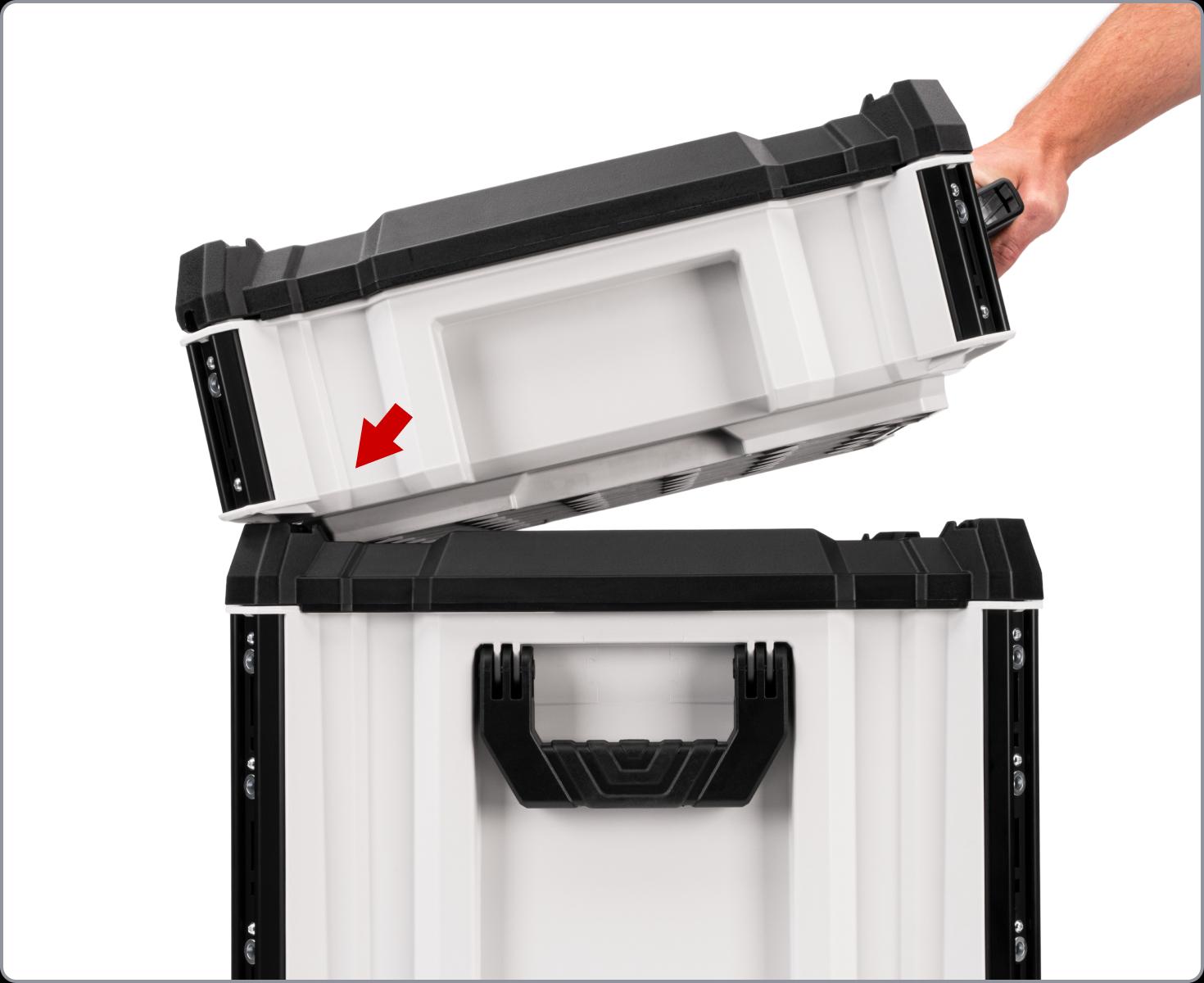 A tool box being hooked onto another box, with a red arrow pointing to the back of the box