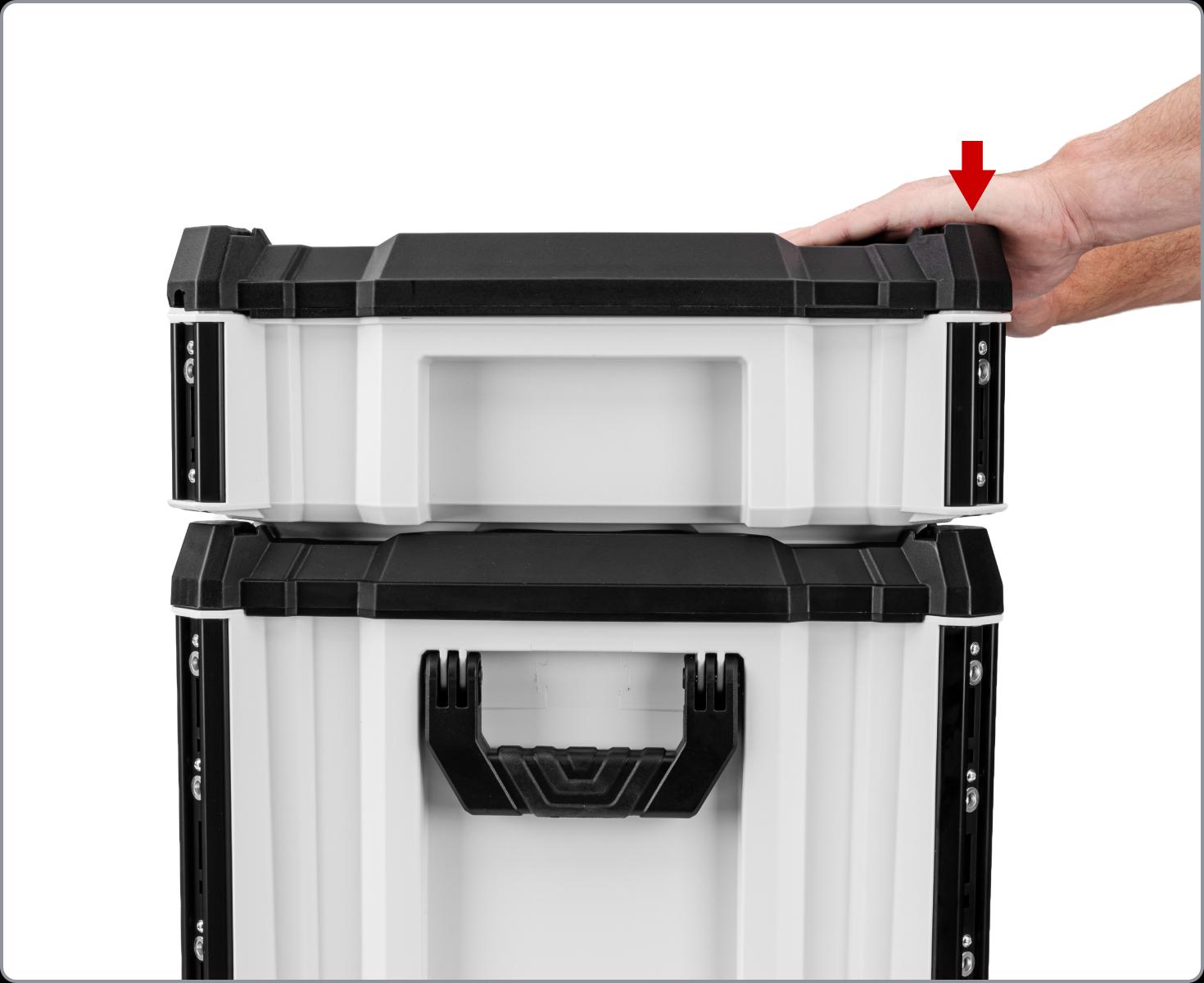 Hands pushing a tool box onto another box, with a red arrow highlighting the front of the box