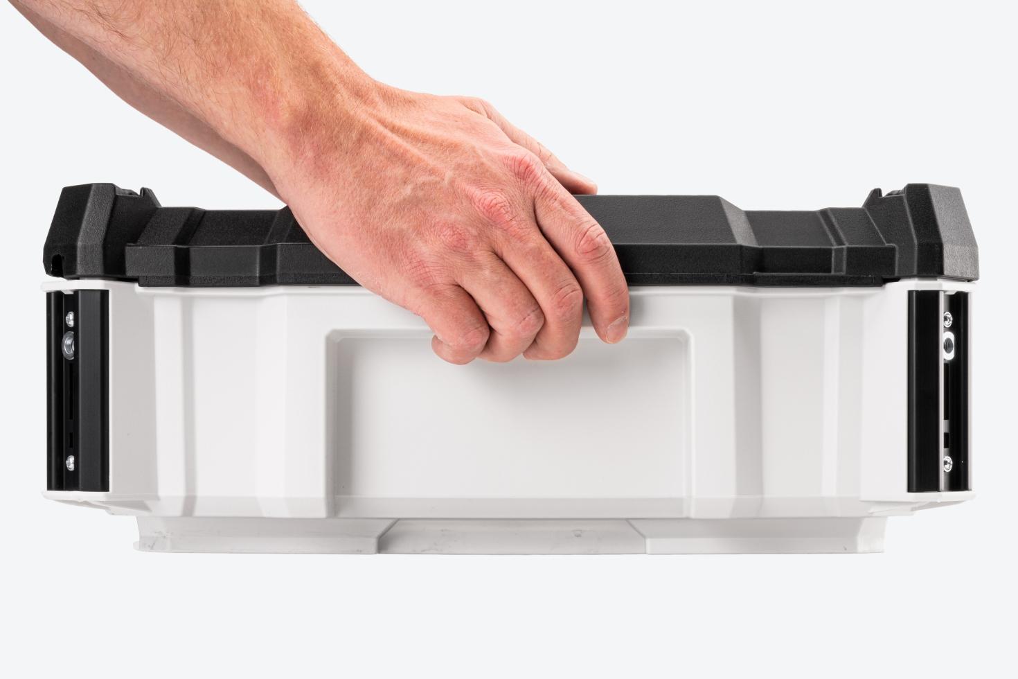 A tool box being held by the side handholds